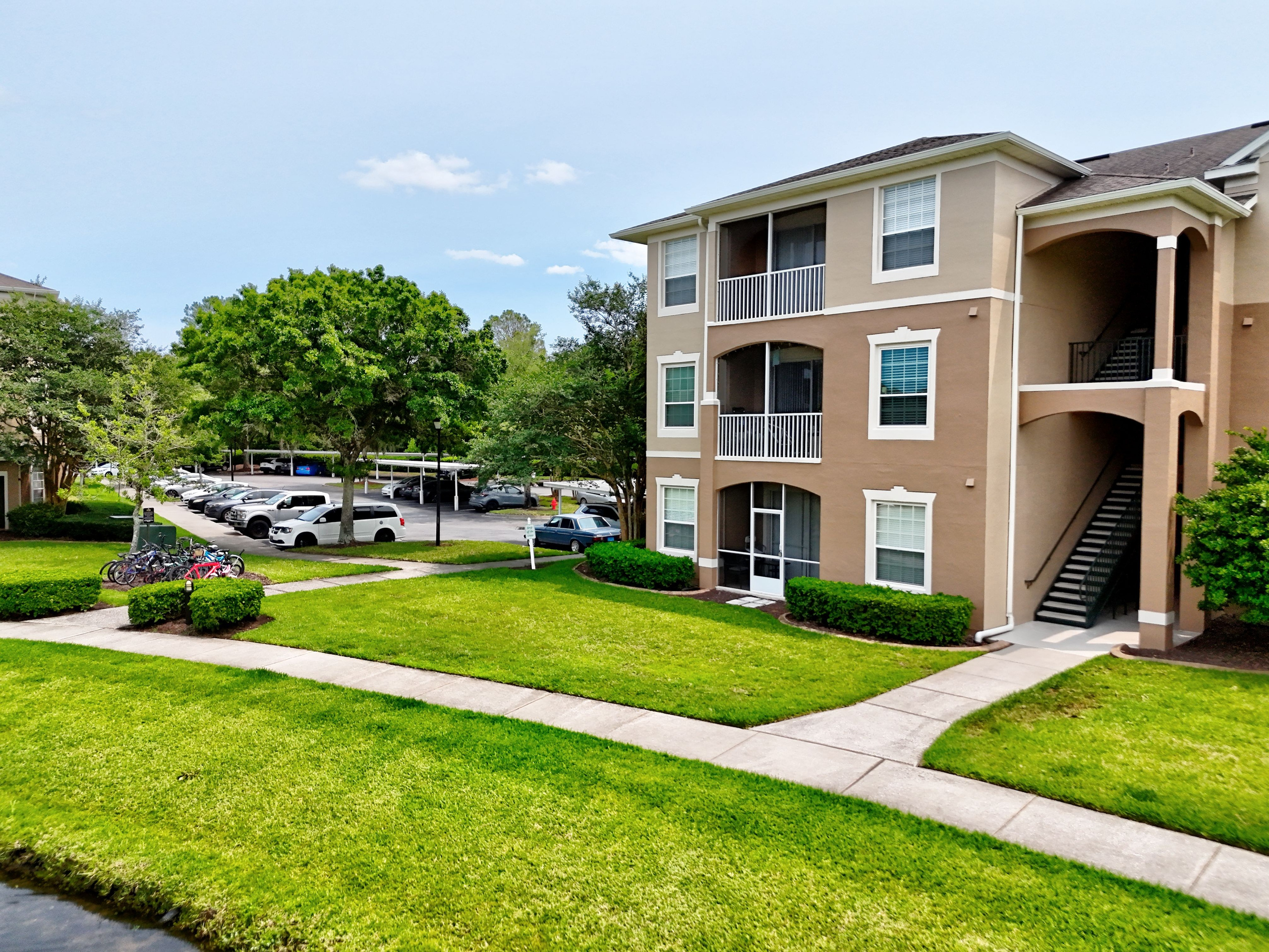 Florida apartment complex with landscaped courtyard and parking
