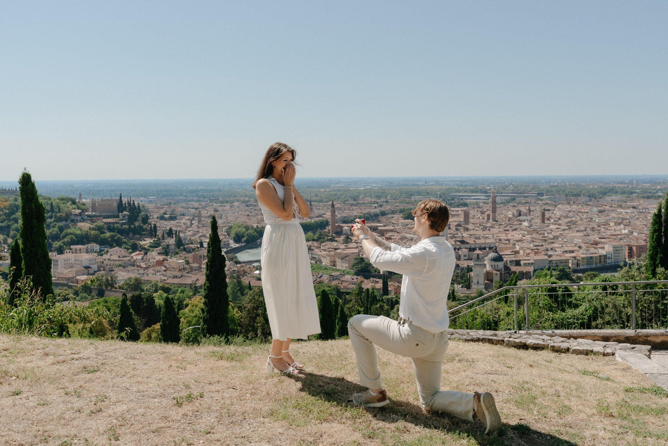 Emotional engagement photography in Verona featuring a stunning city skyline and intimate proposal moment.