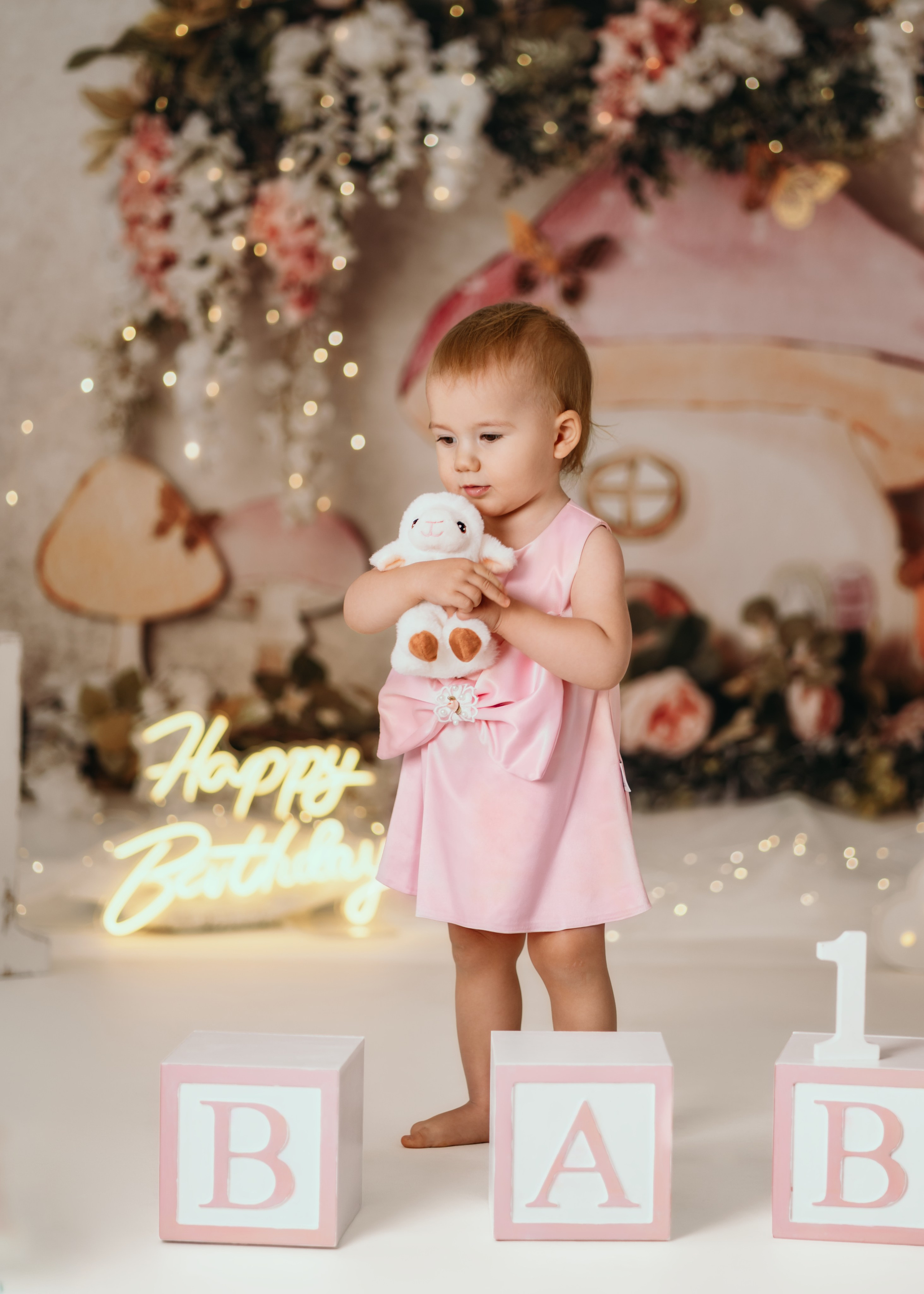 devojcica grli igracku medju balonima