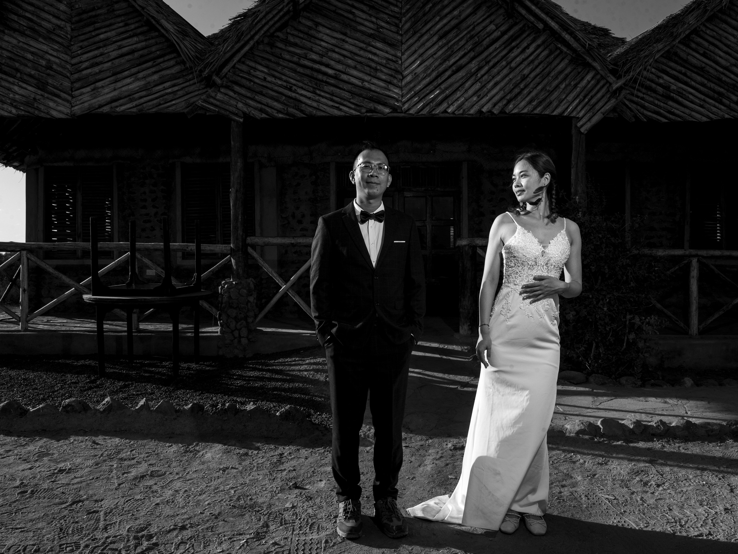 A black and white photo of a Chinese couple, at their destination wedding in Amboseli National park. Destination wedding photography