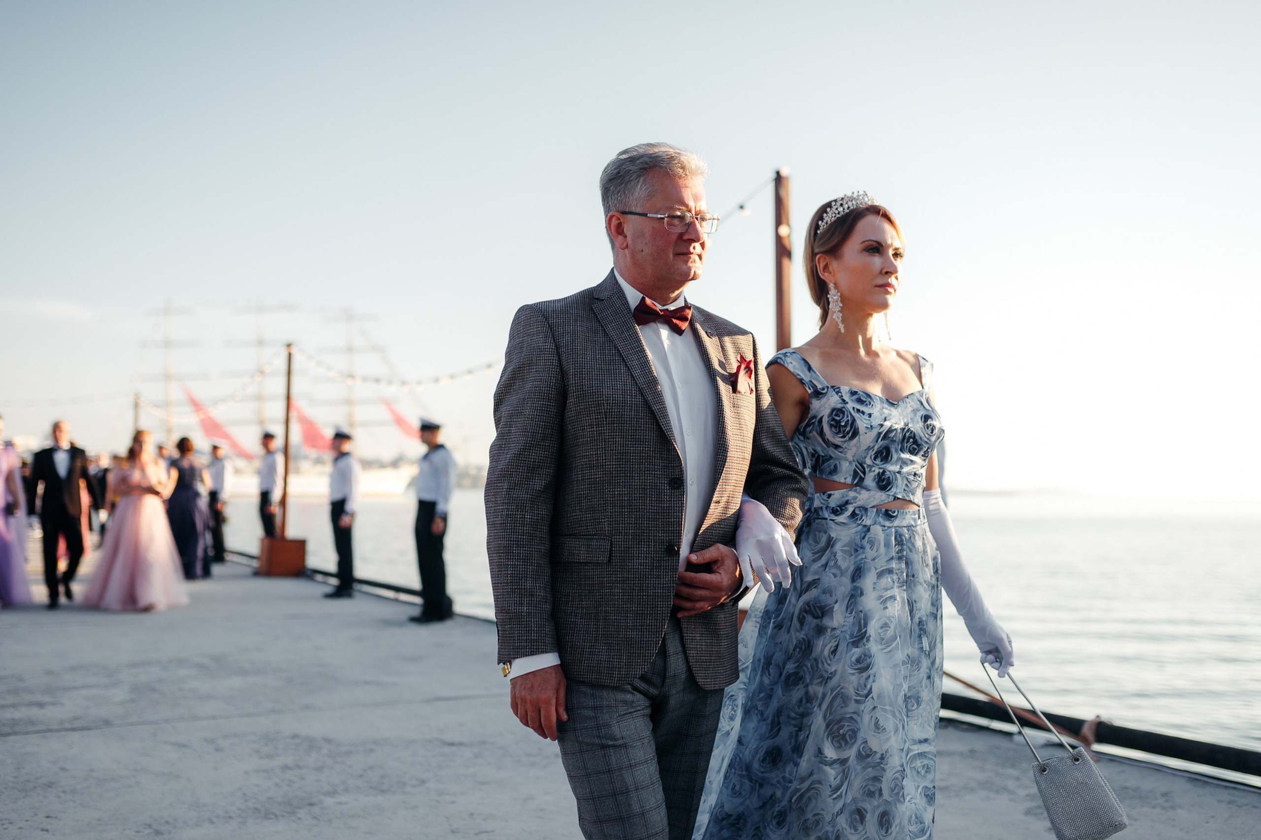 Grooms walking hand in hand, beach wedding ceremony