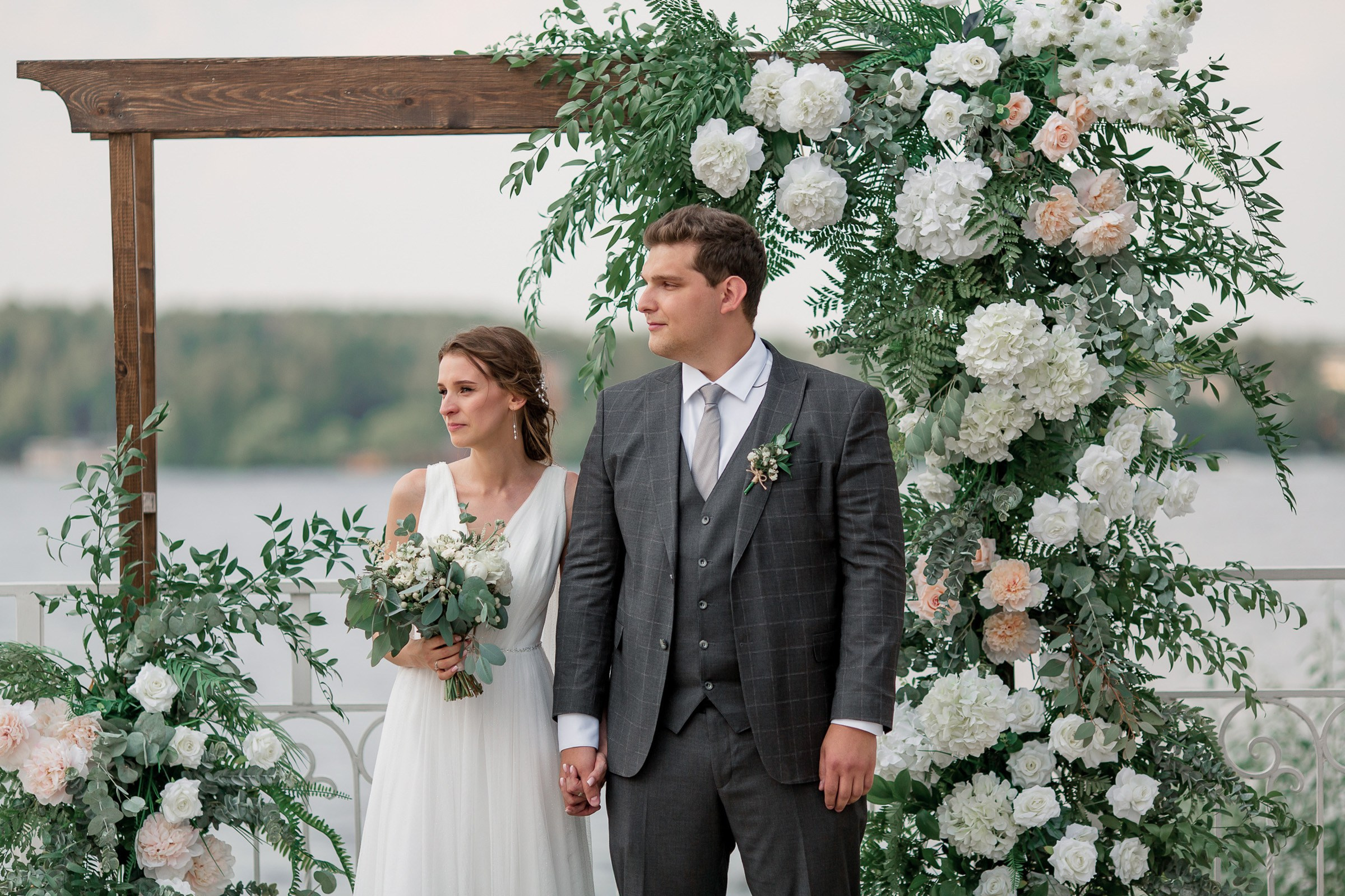 Couple holding hands by river, by Tanya Bodgan, Bude, Cornwall wedding photography.