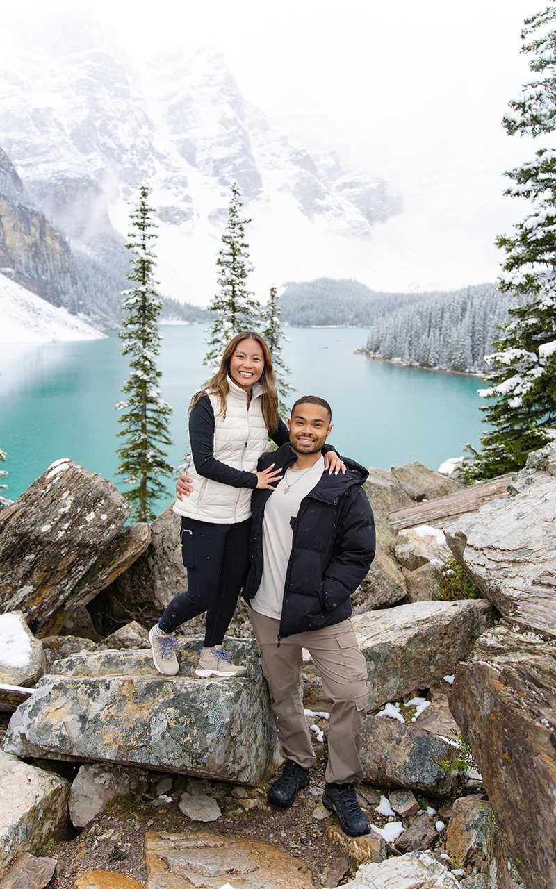 Woman at Lake Louise with turquoise water and mountains