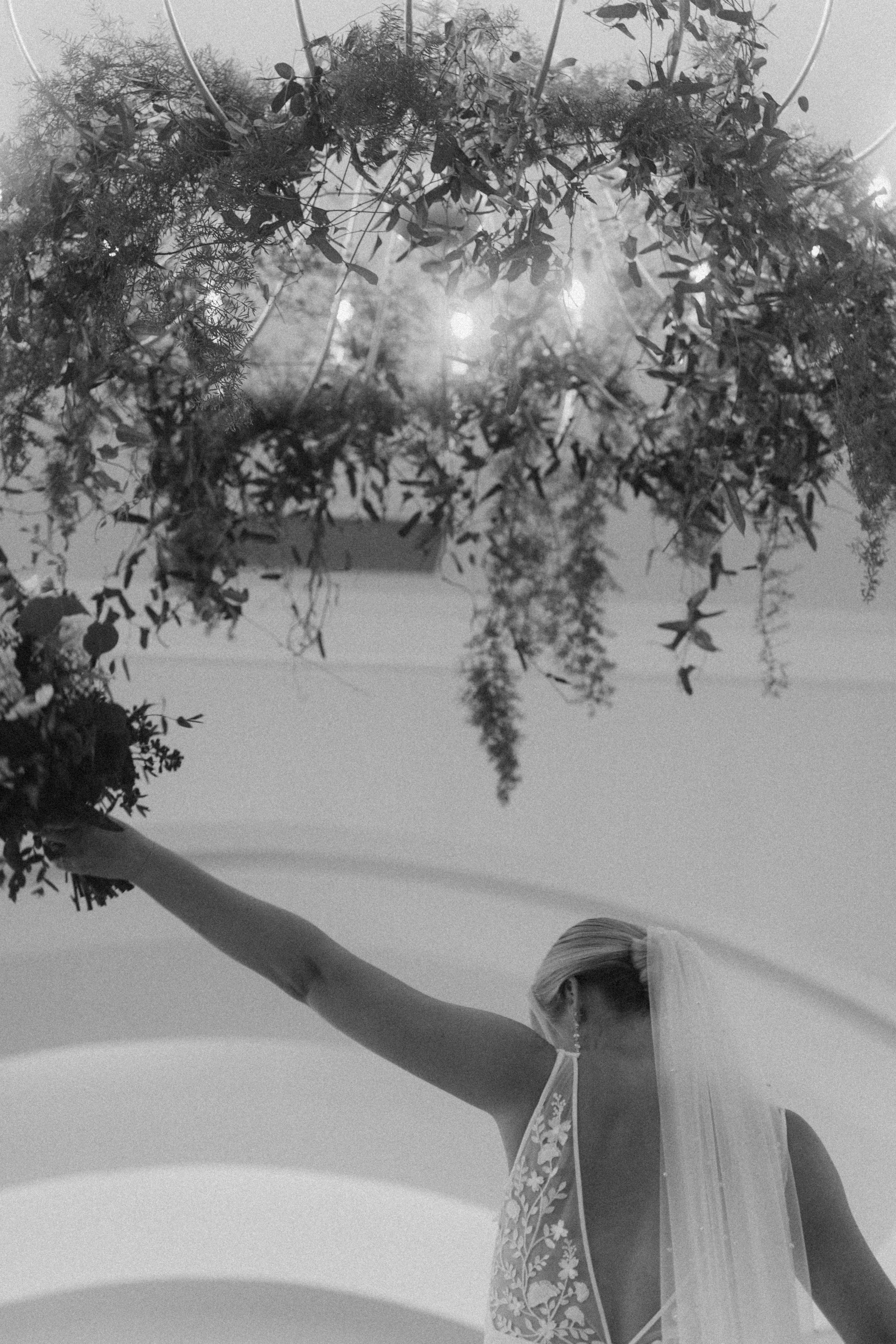 Bride with bouquet walking Albany Empire Plaza steps..