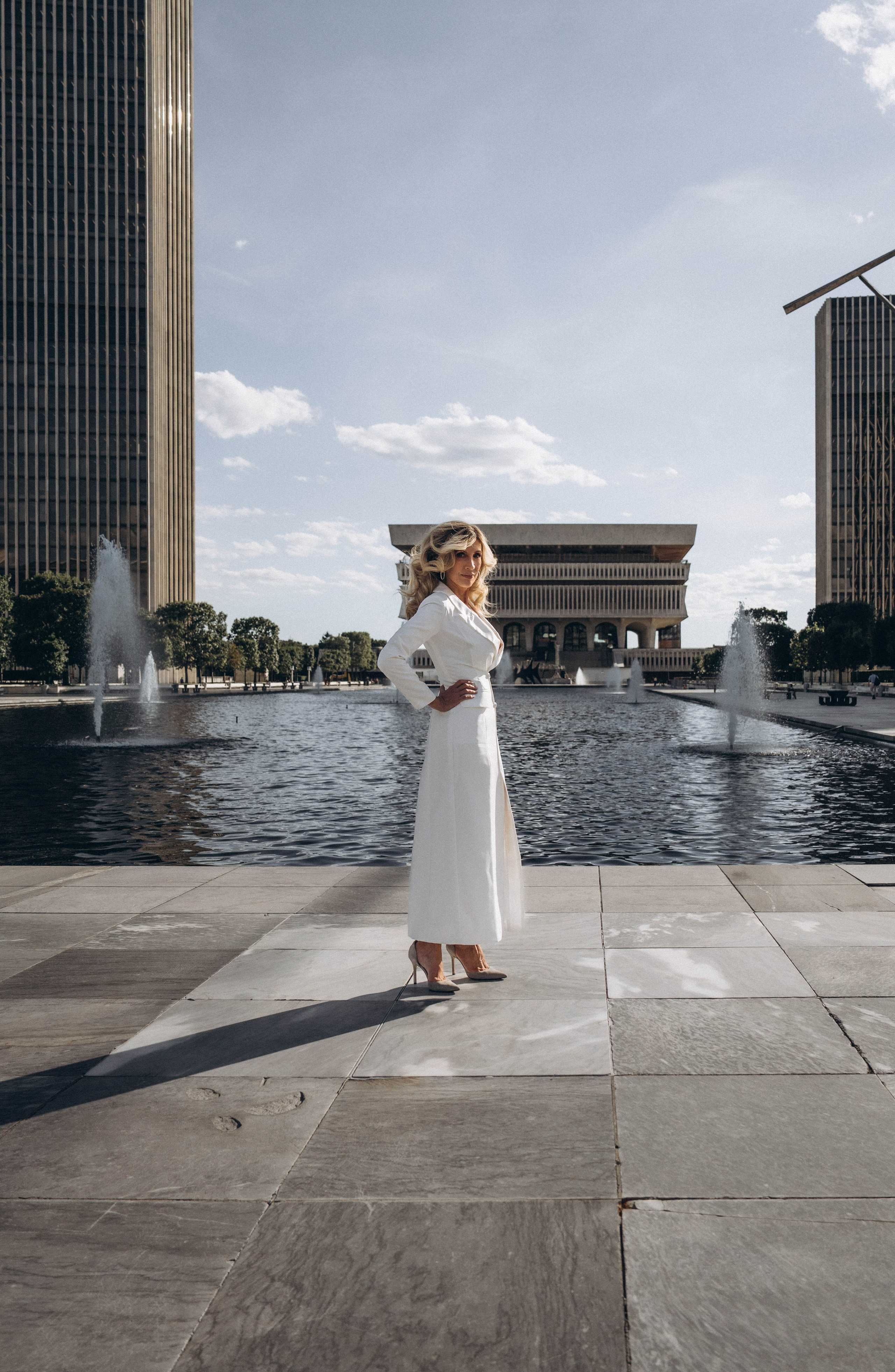 Bride walking by Lake George shoreline at golden sunset.