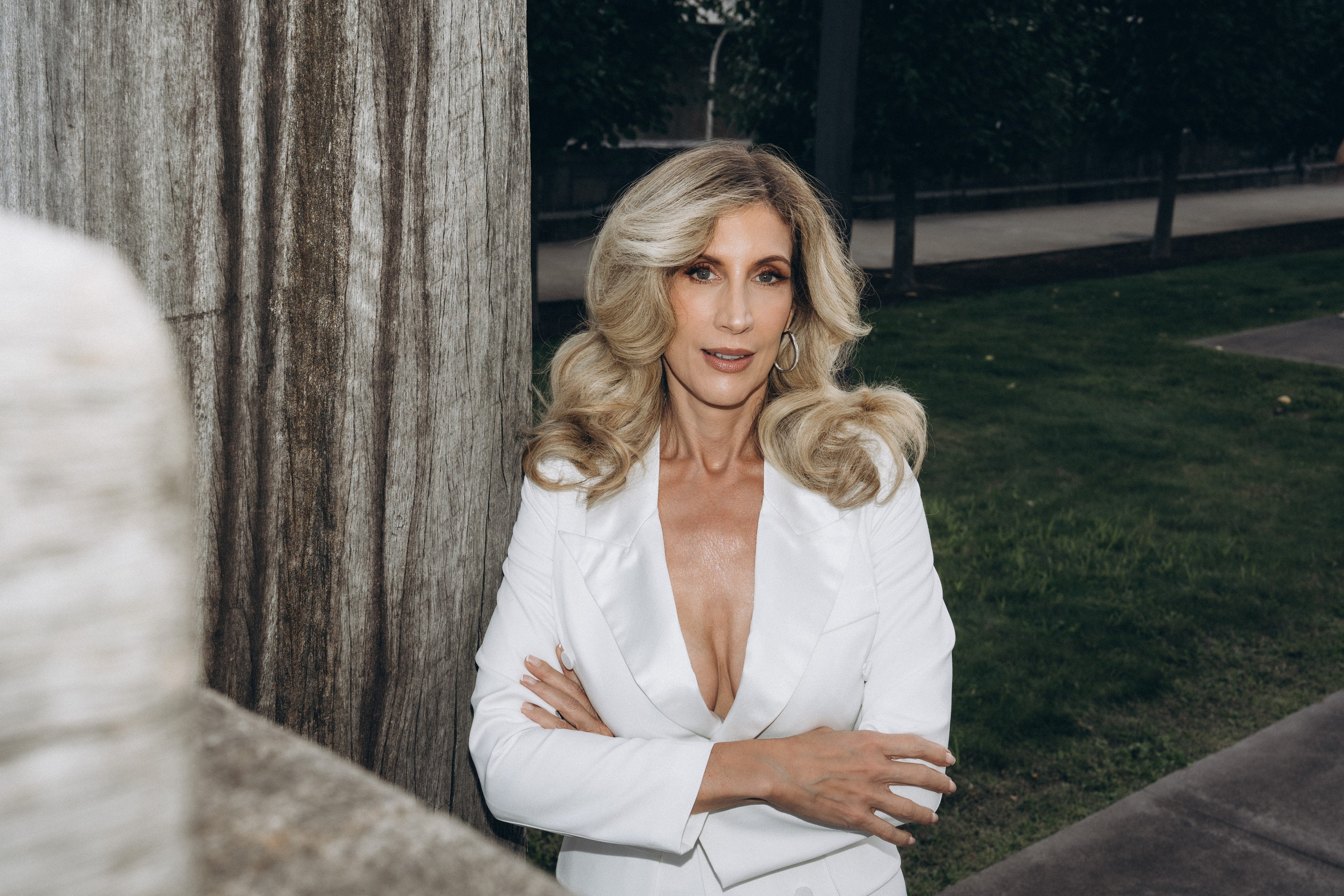 Bride gazing over Lake George with sailboats behind.
