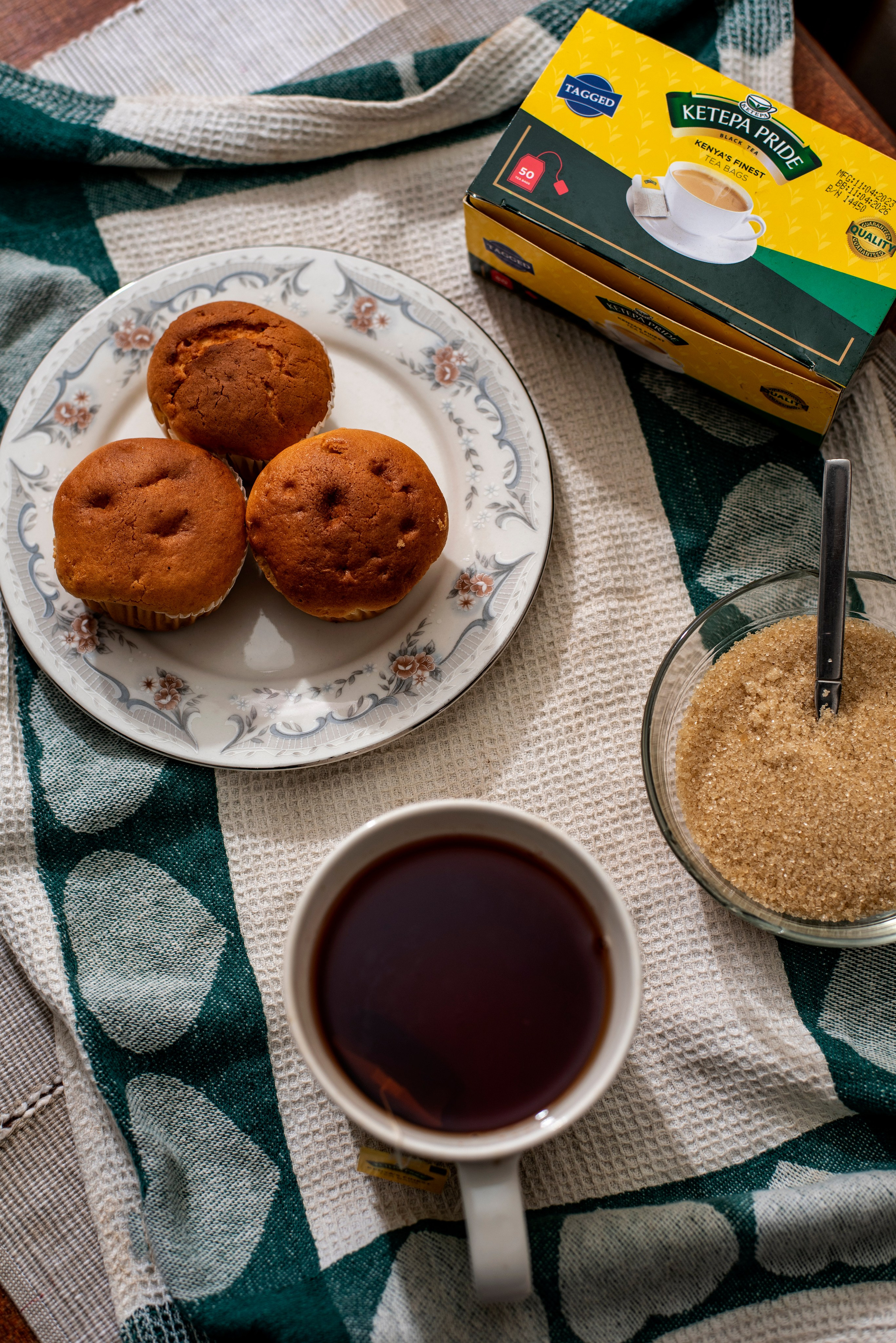 Black Ketepa tea and chocolate muffins on wooden table – Kenyan food shoot
