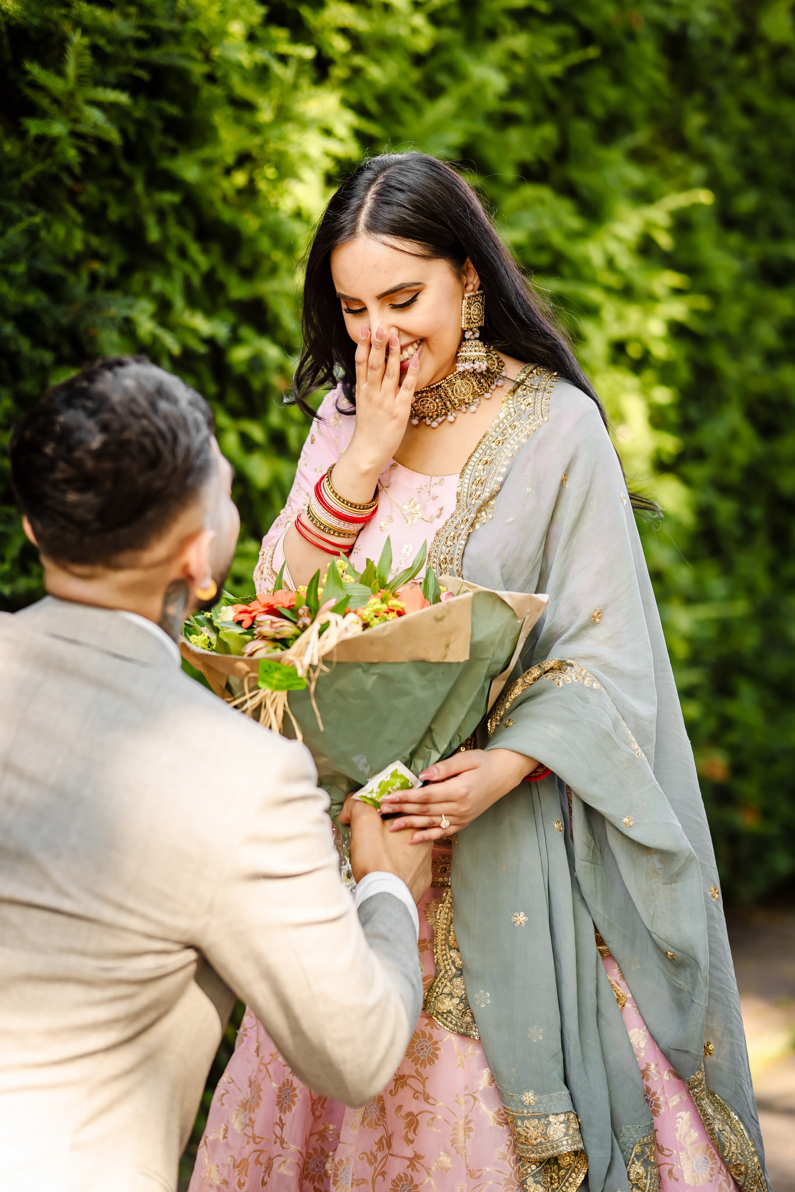 a woman acting surprised after a proposal from a man
