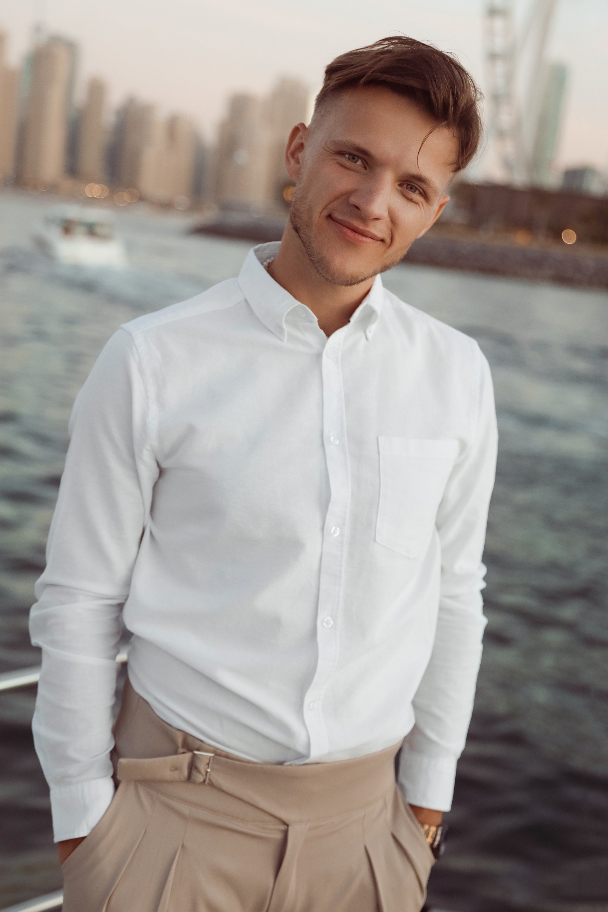 A man looks out at the horizon from the deck of a yacht in Dubai, United Arab Emirates