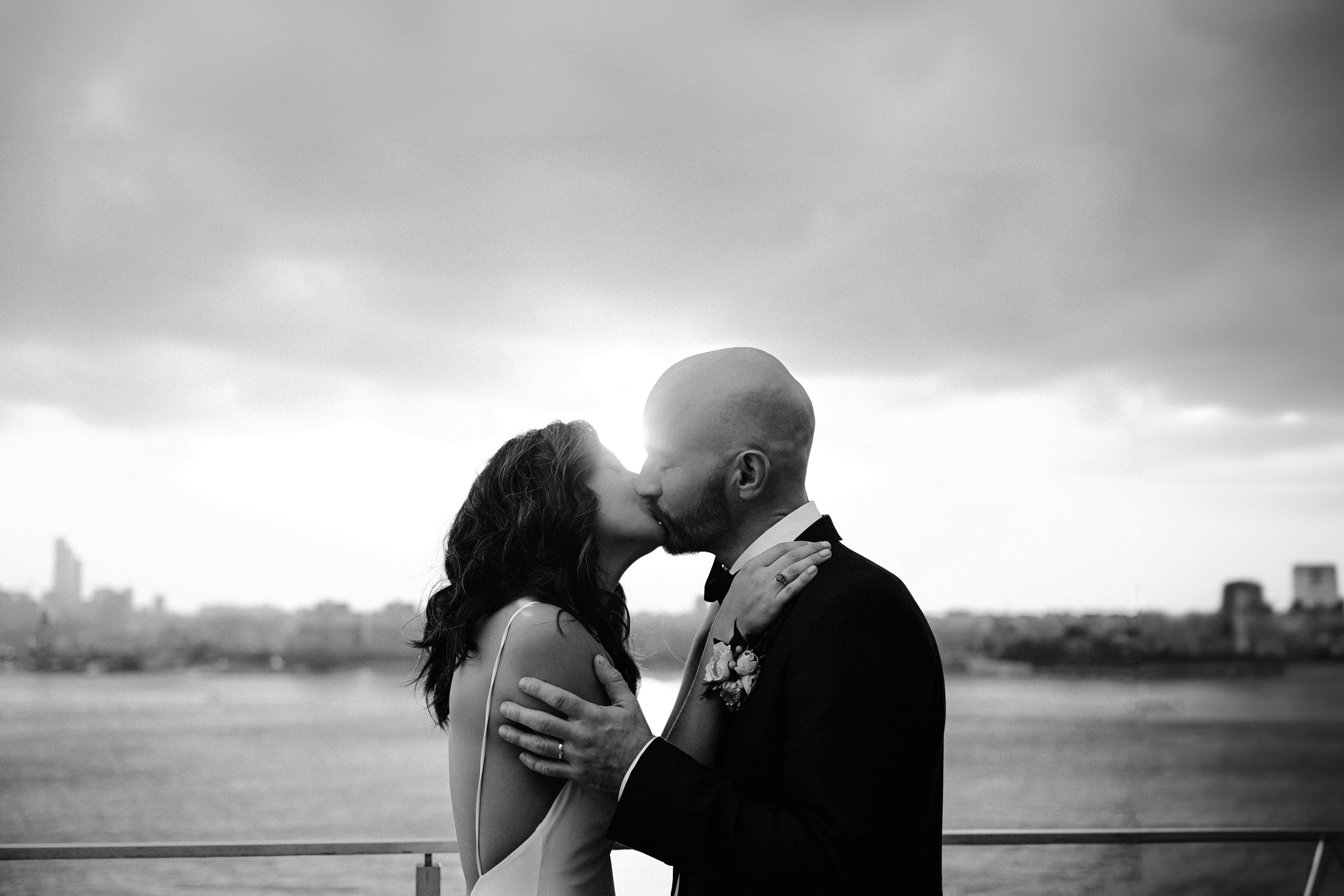 a man and woman kissing on a boat