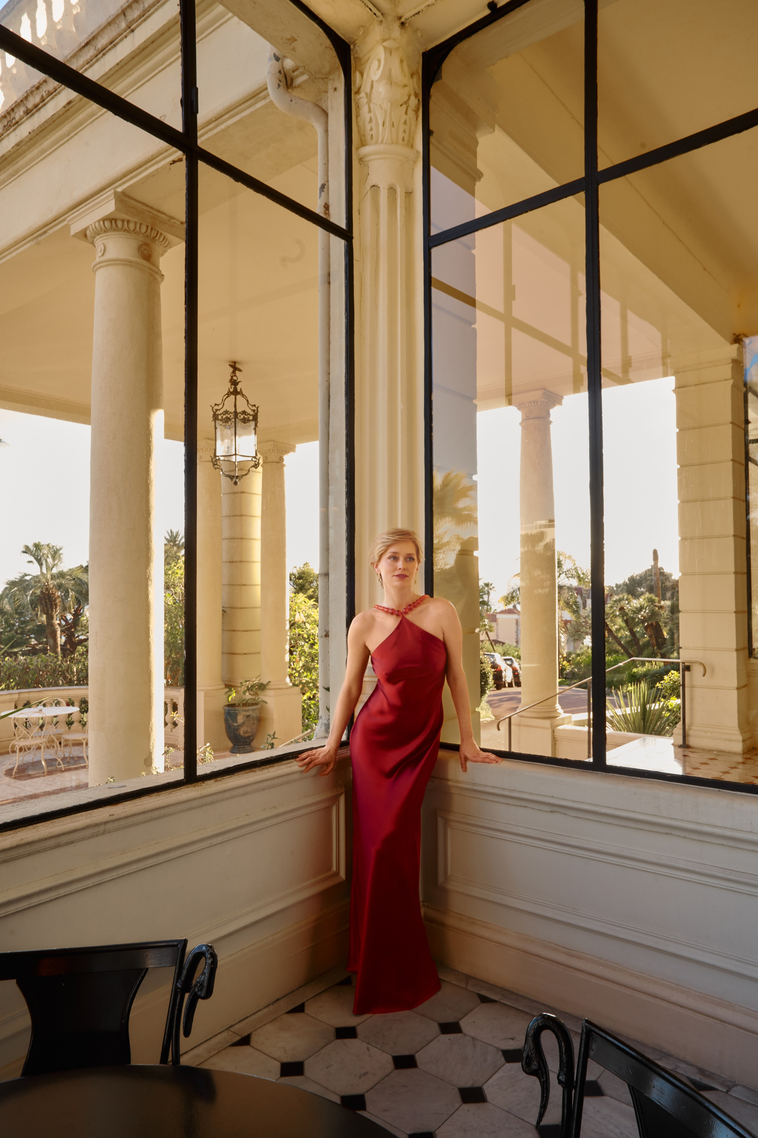 Fashion portrait of woman with soft natural light inside luxury Cannes hotel