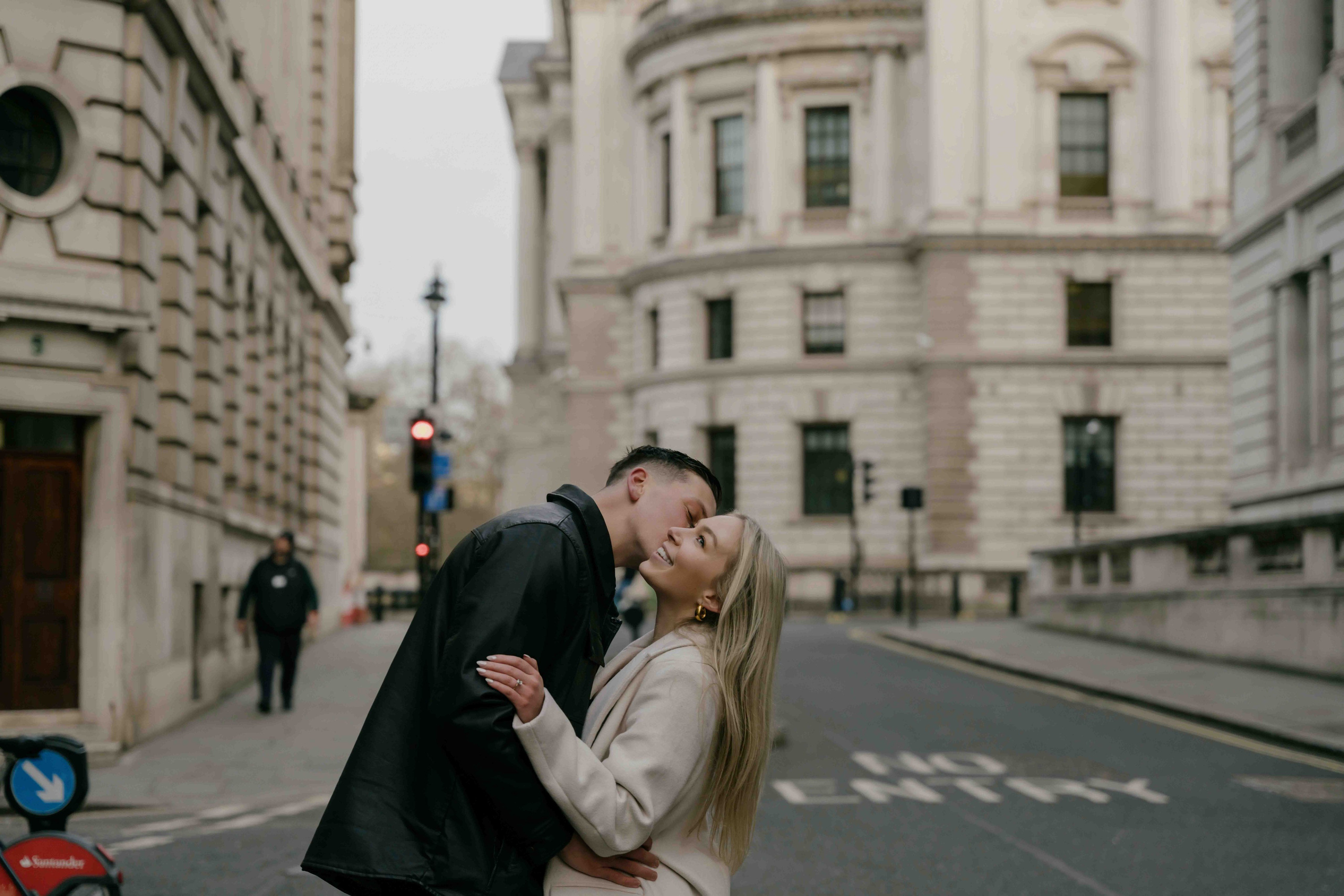 Romantic couple kissing in Westminster London sunrise engagement
