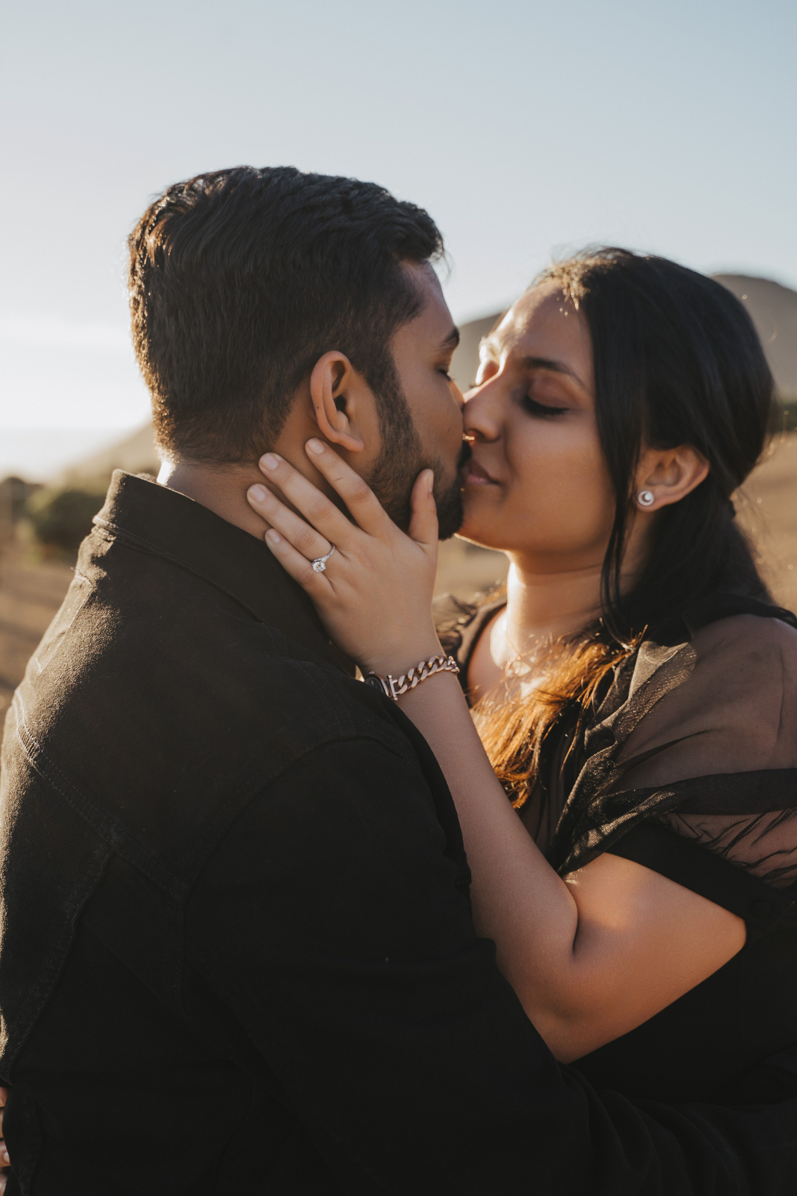 Proposal.  Overlooking the golden San Franisco Bridge sunset with a couple. Photographer Video. 