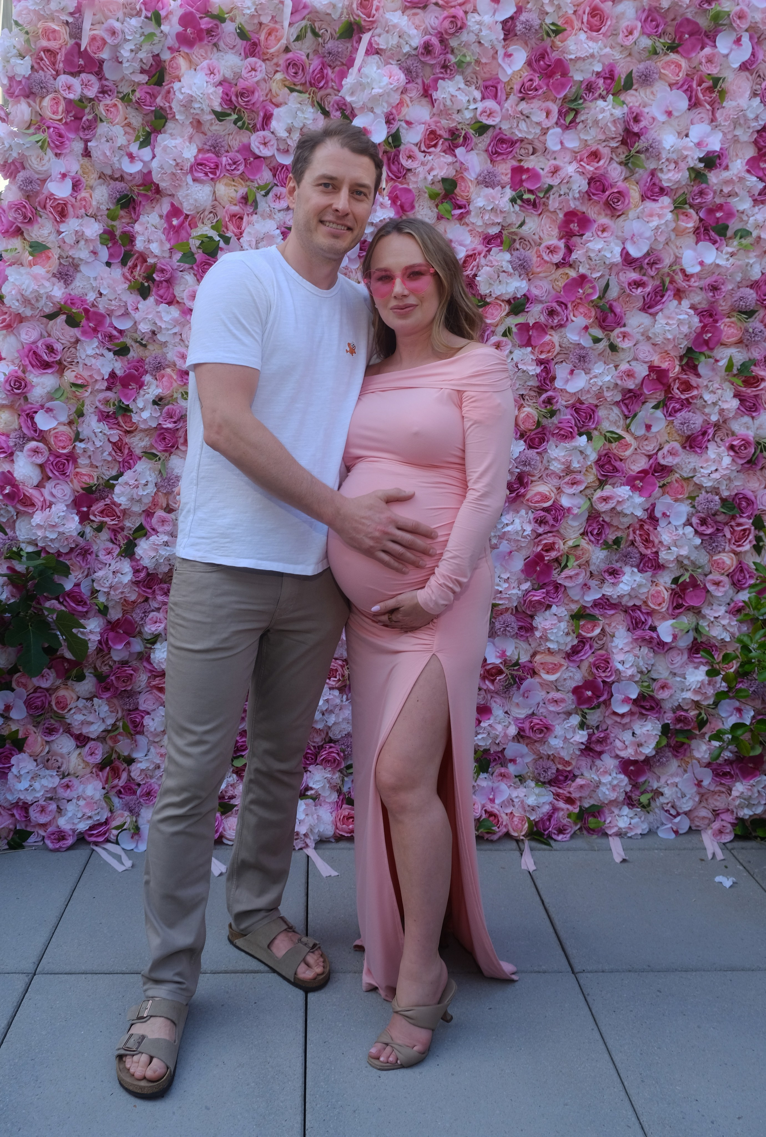 Hands on baby bump in a warm, sunlit room