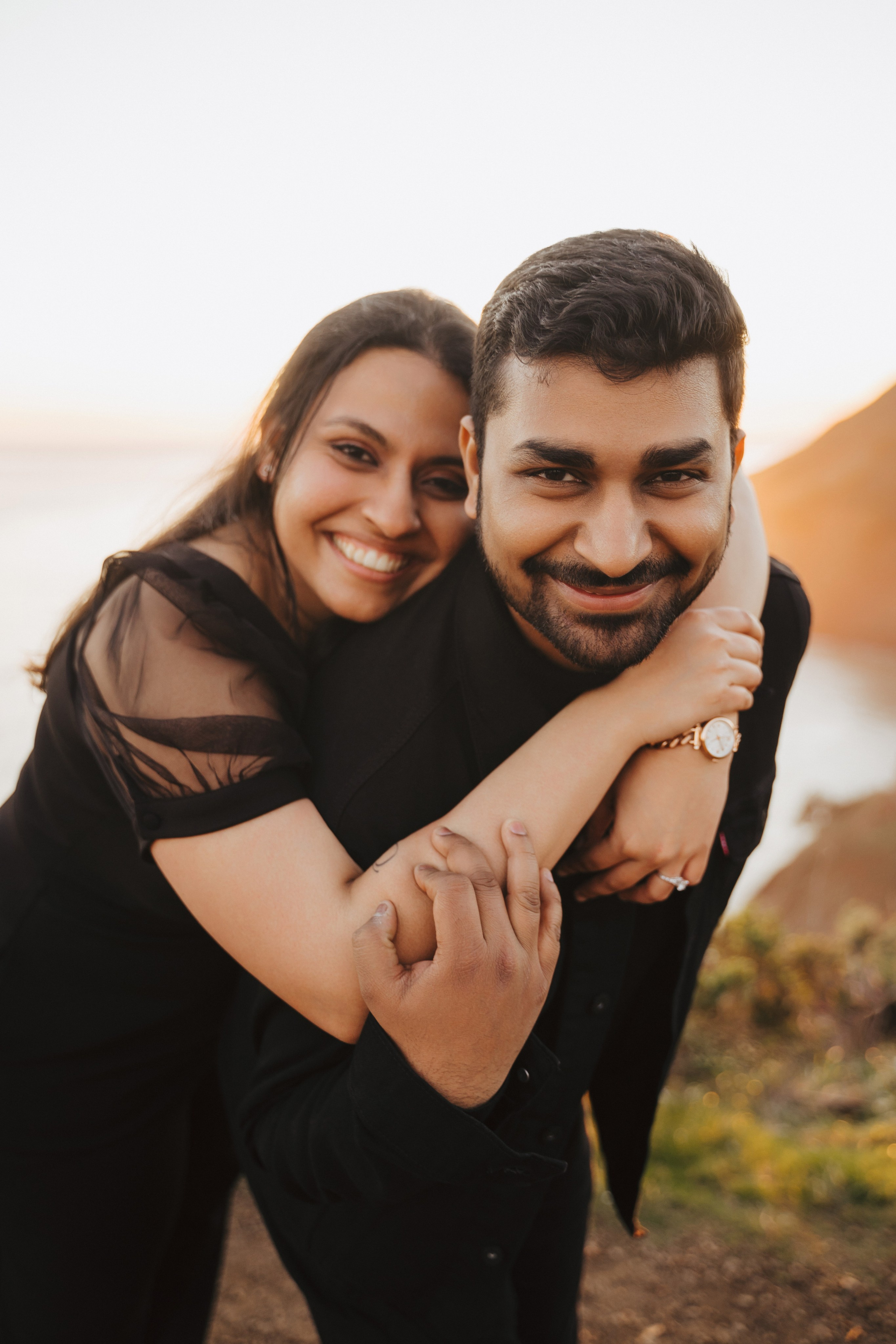 Proposal.  Overlooking the golden San Franisco Bridge sunset with a couple. Photographer Video. 