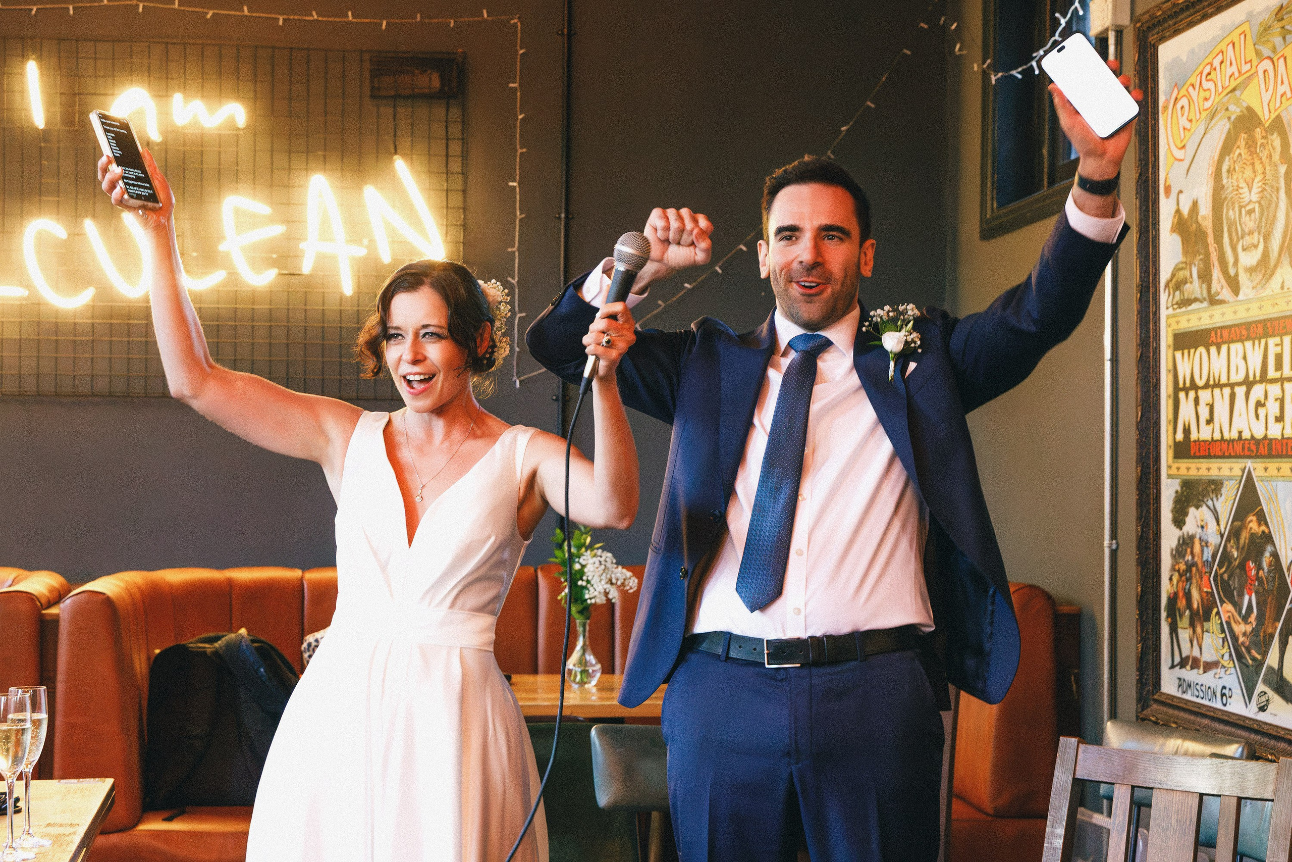 Newlyweds celebrating with a microphone at their pub wedding reception