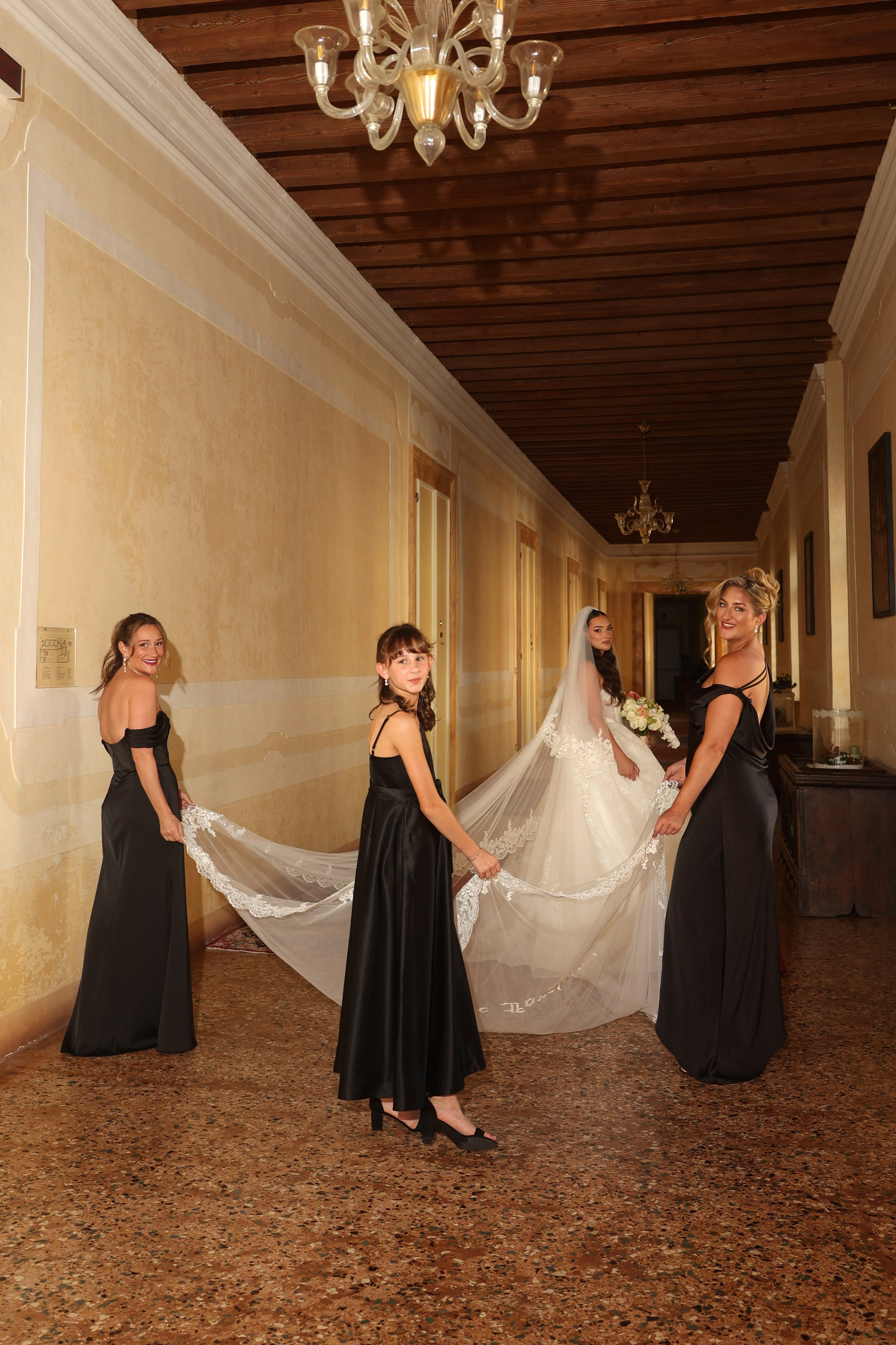 Candid moment of the bride surrounded by bridesmaids during preparations.