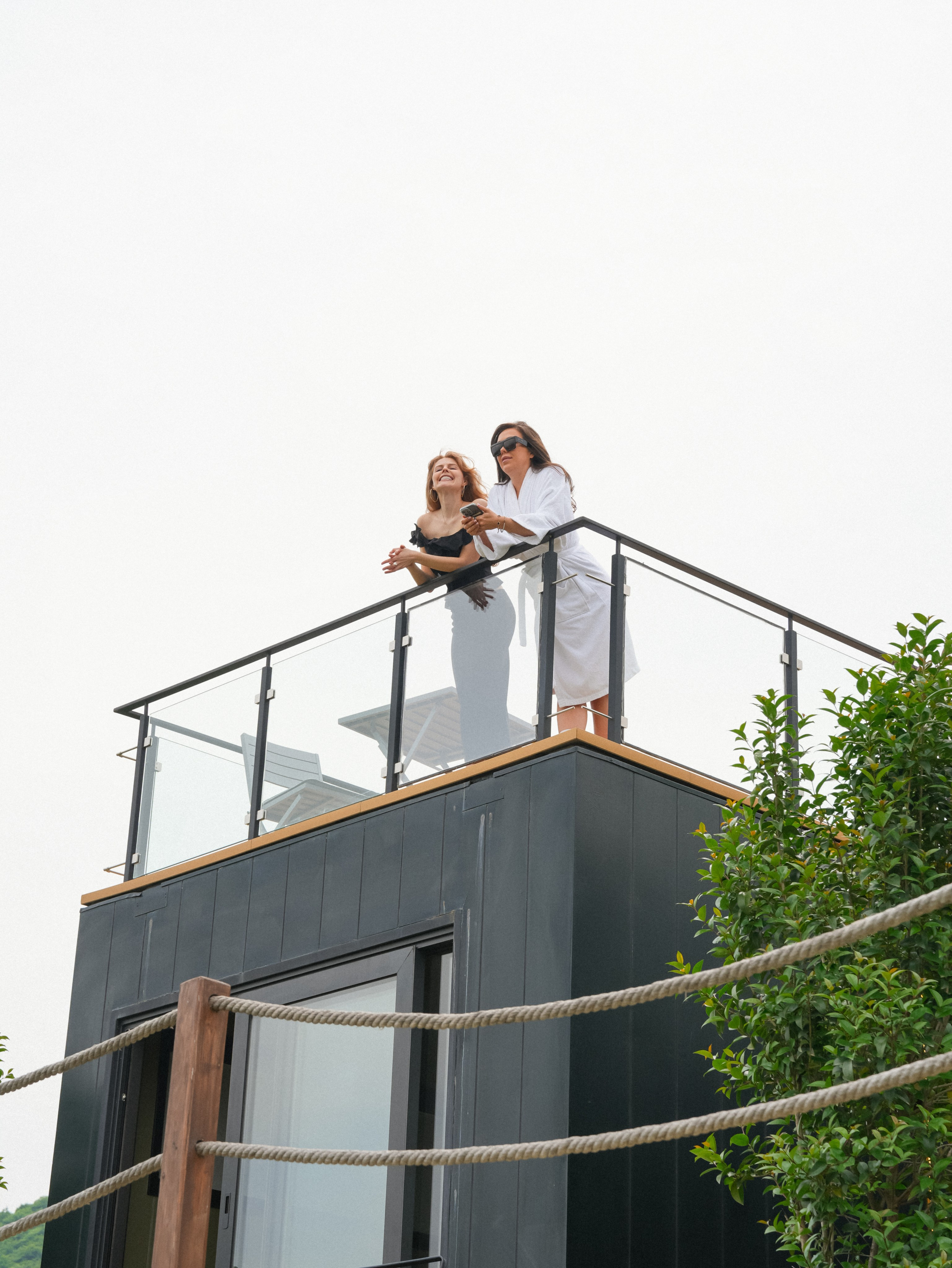 Bride and bridesmaid on rooftop overlooking Kakheti landscape