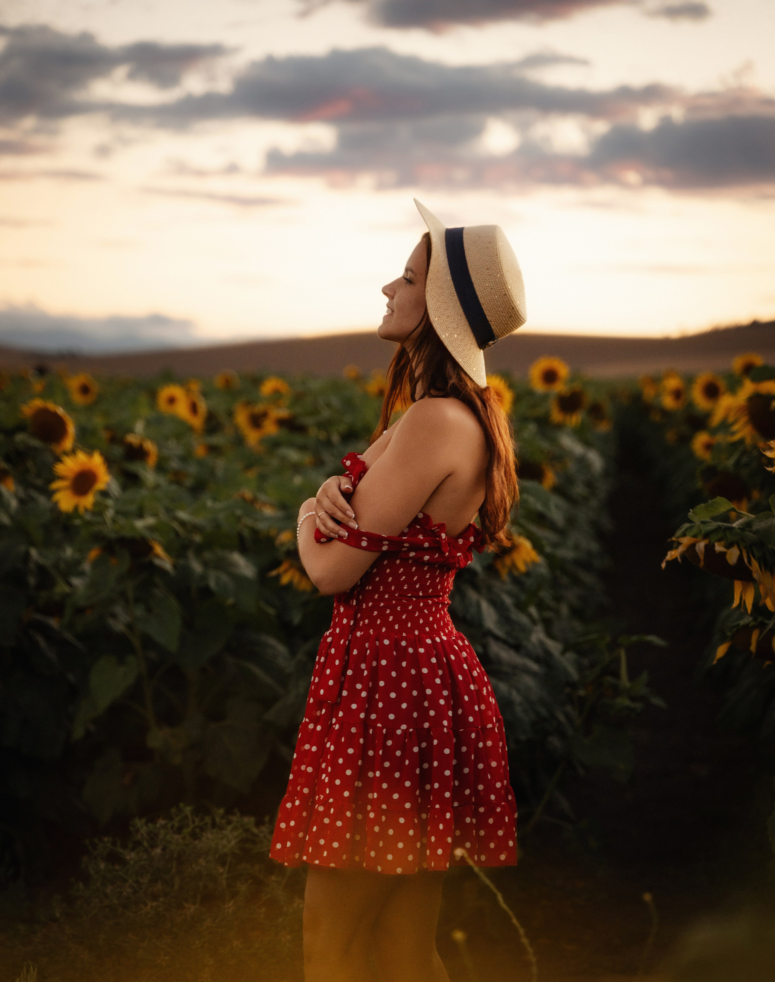 Charming portrait of female model at sunset in sunflower field by Marbella-based photographer