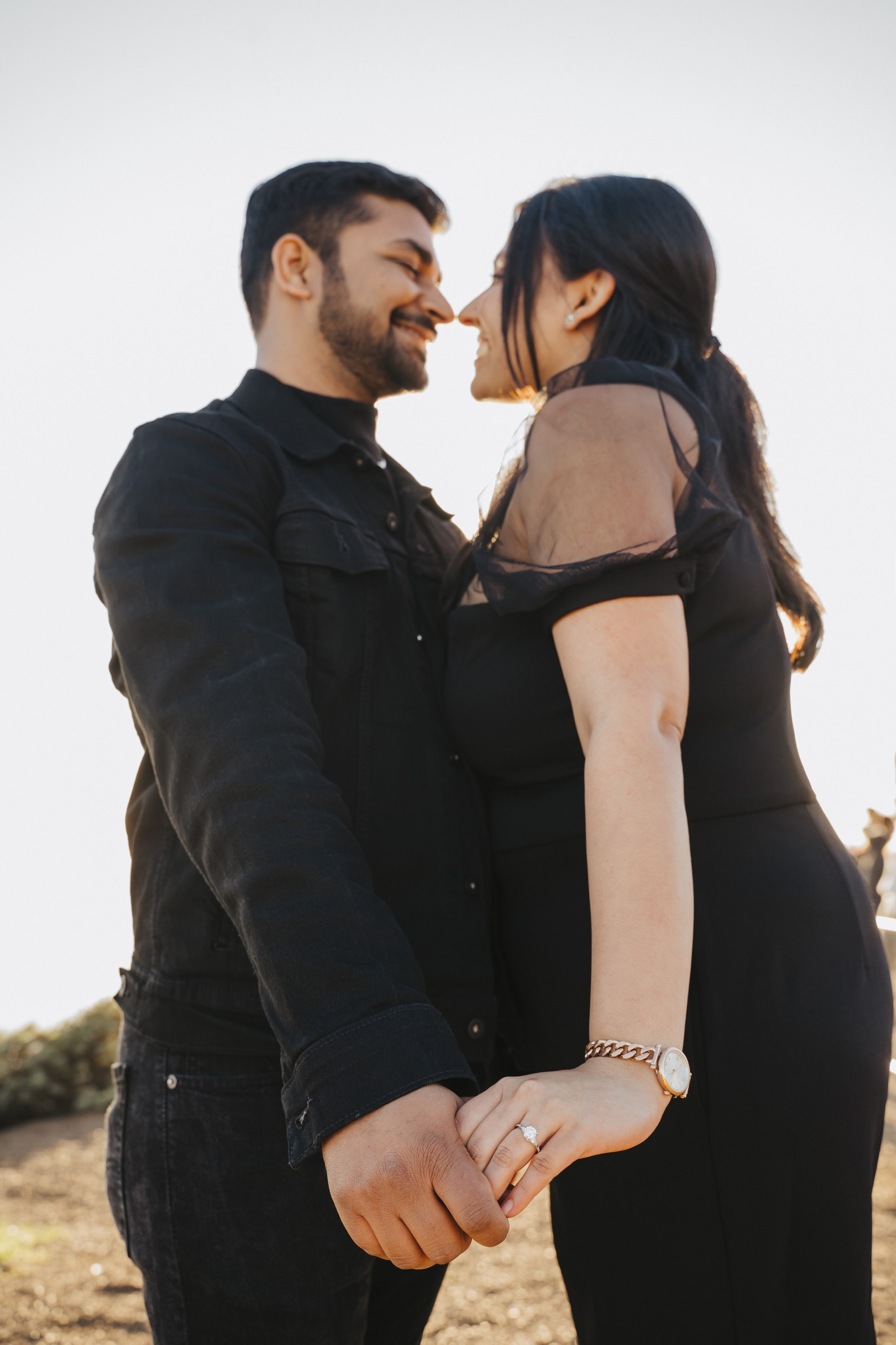 Proposal.  Overlooking the golden San Franisco Bridge sunset with a couple. Photographer Video. 