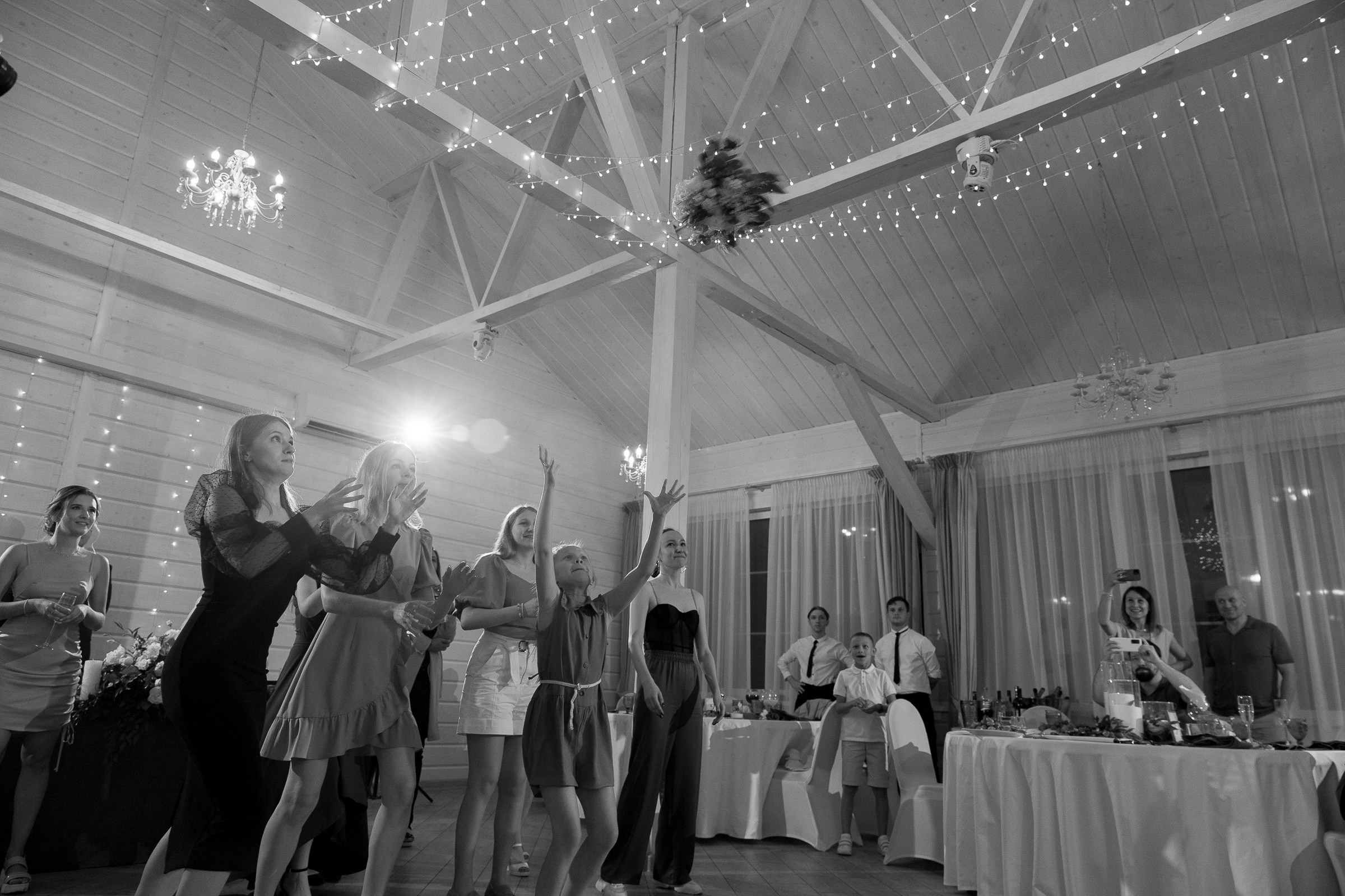 Bouquet toss catch at reception, by Bude, Cornwall reportage photographer.