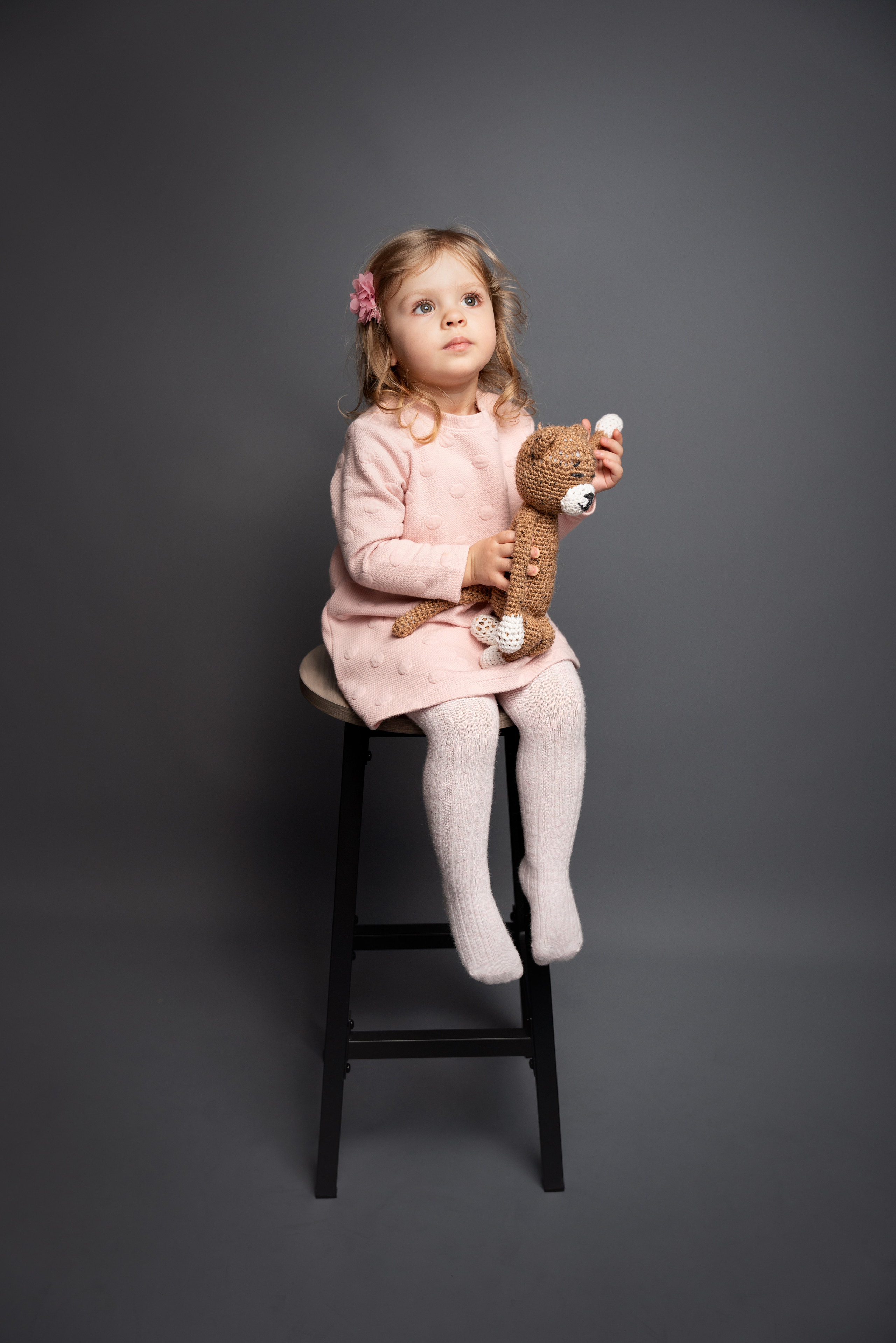 Mädchen mit großen Augen, die ein Spielzeug umarmen