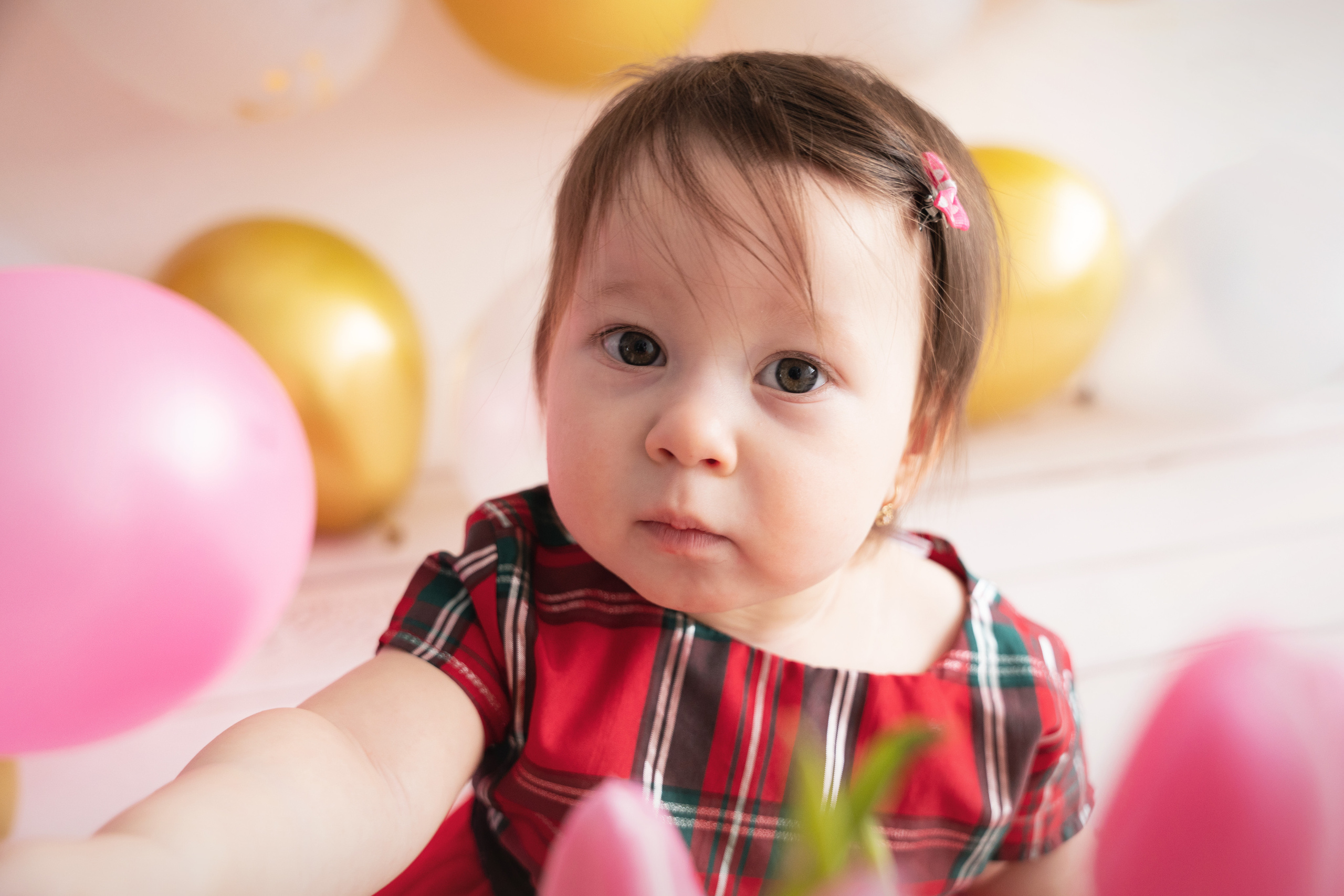 das baby schaut in den rahmen und zieht ihre hände zur kamera