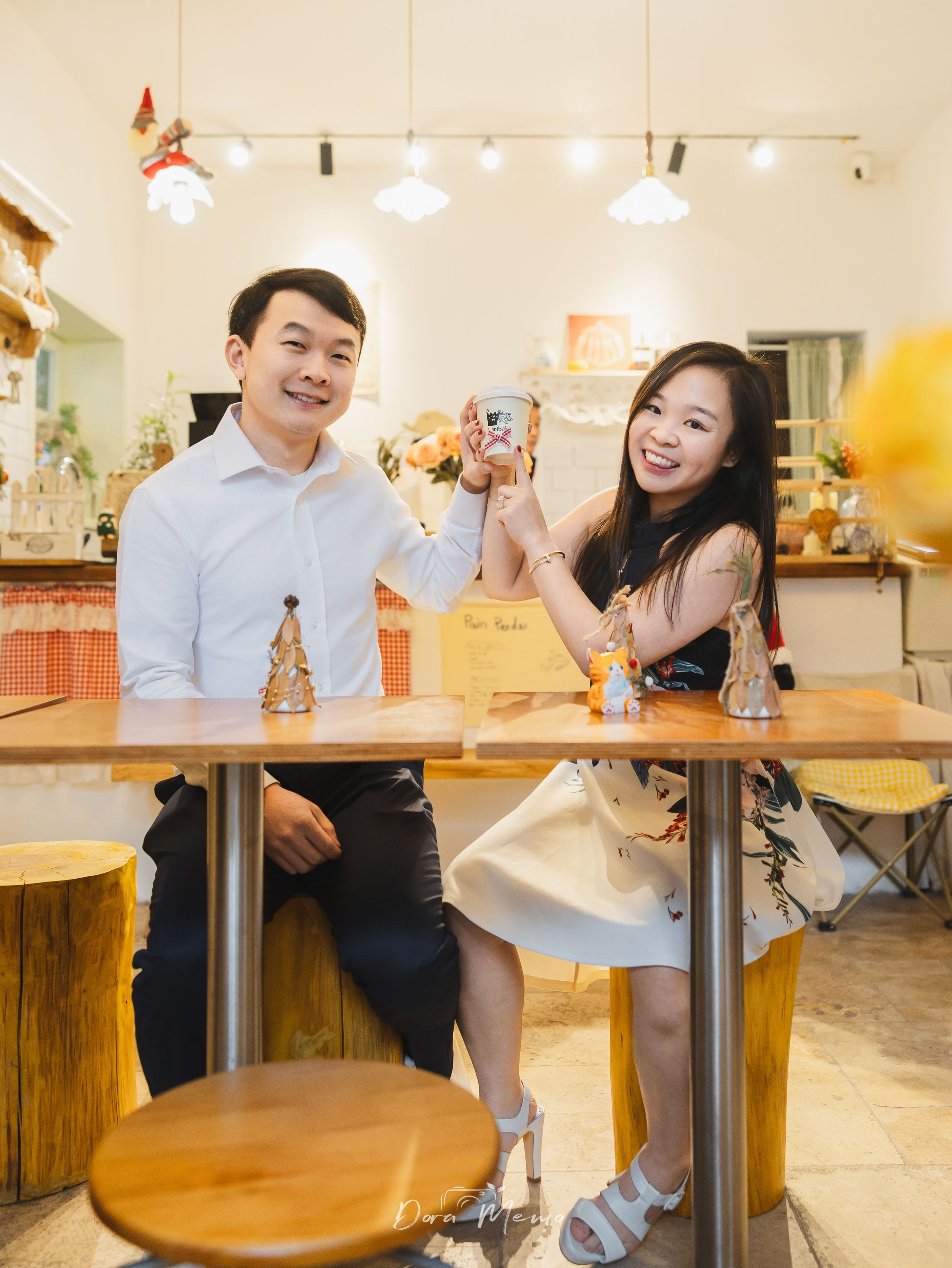 Couple clinking glasses at a neighborhood café, celebrating their engagement 