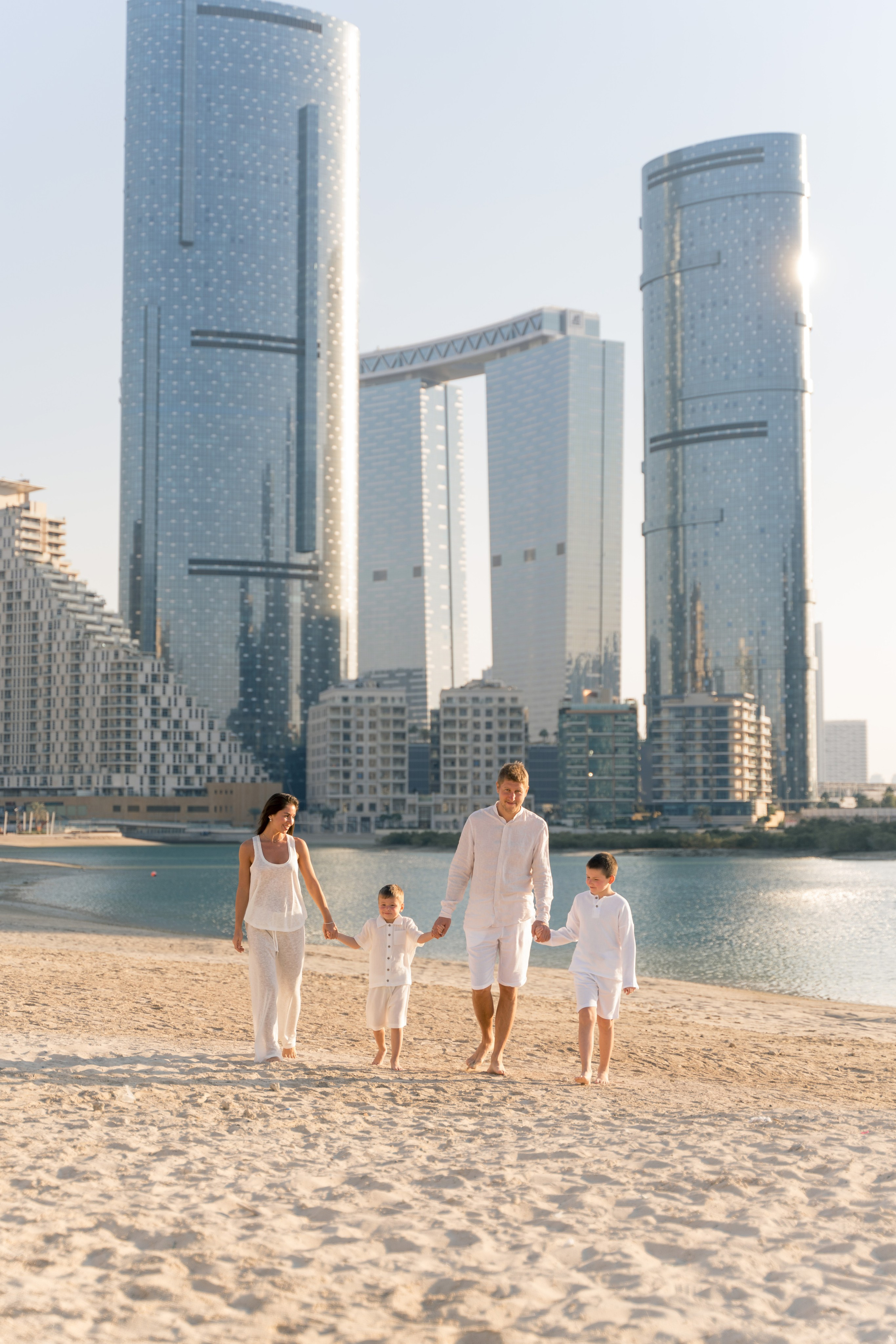 Family photoshoot at Reem Island Abu Dhabi with parents and children by the sea