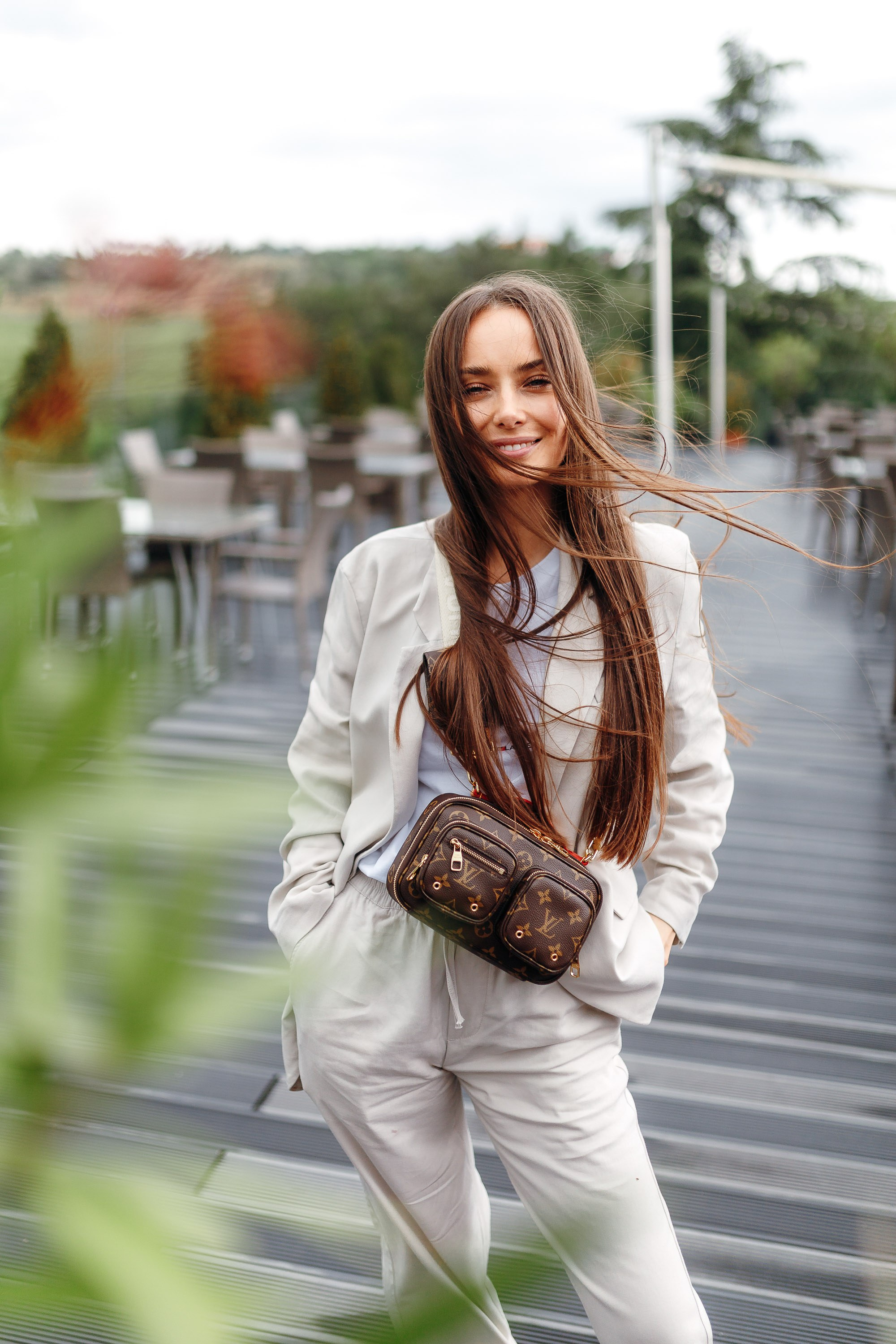 Woman in beige outfit walking on street