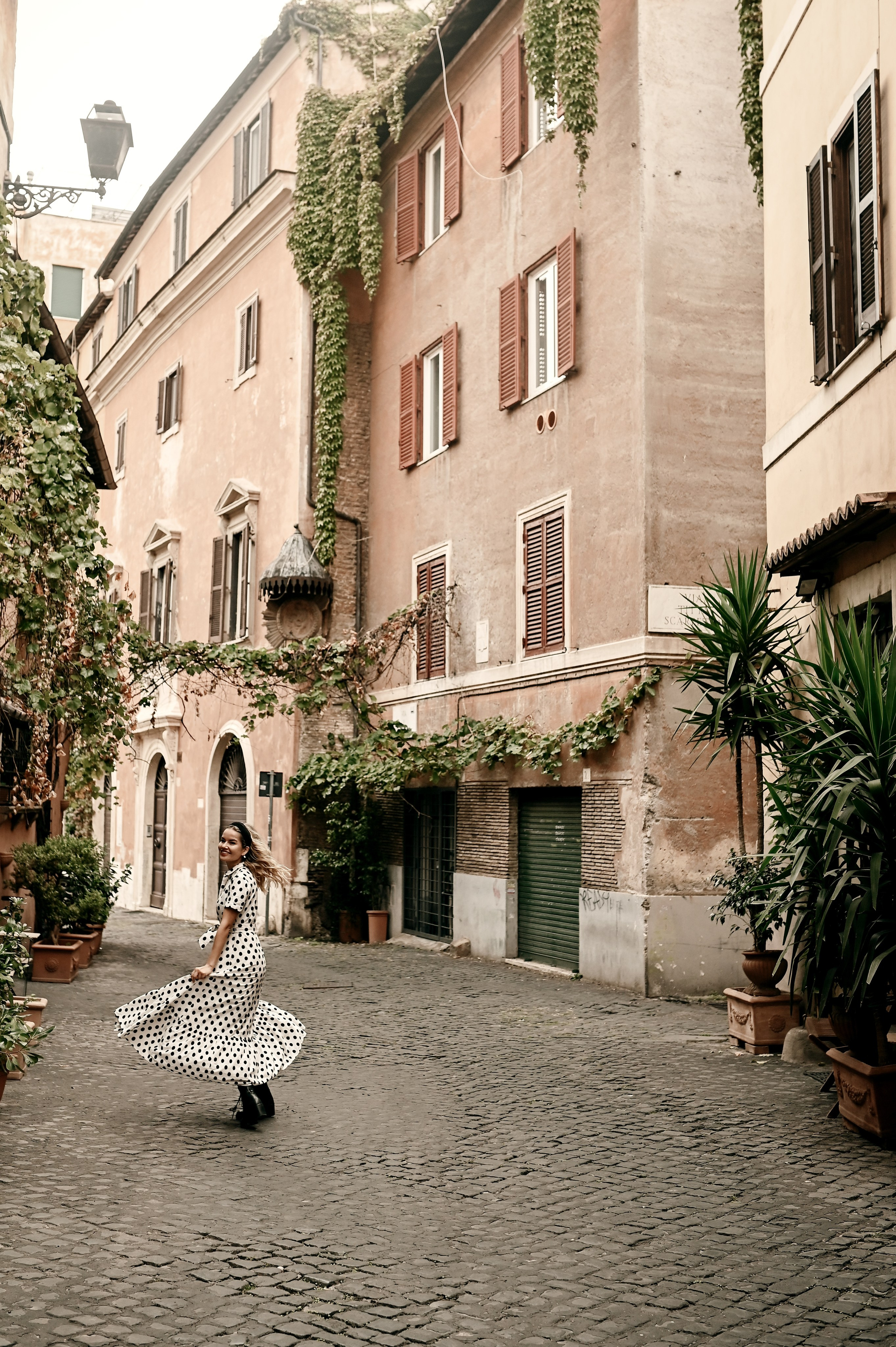 A young woman twirls in Trastevere