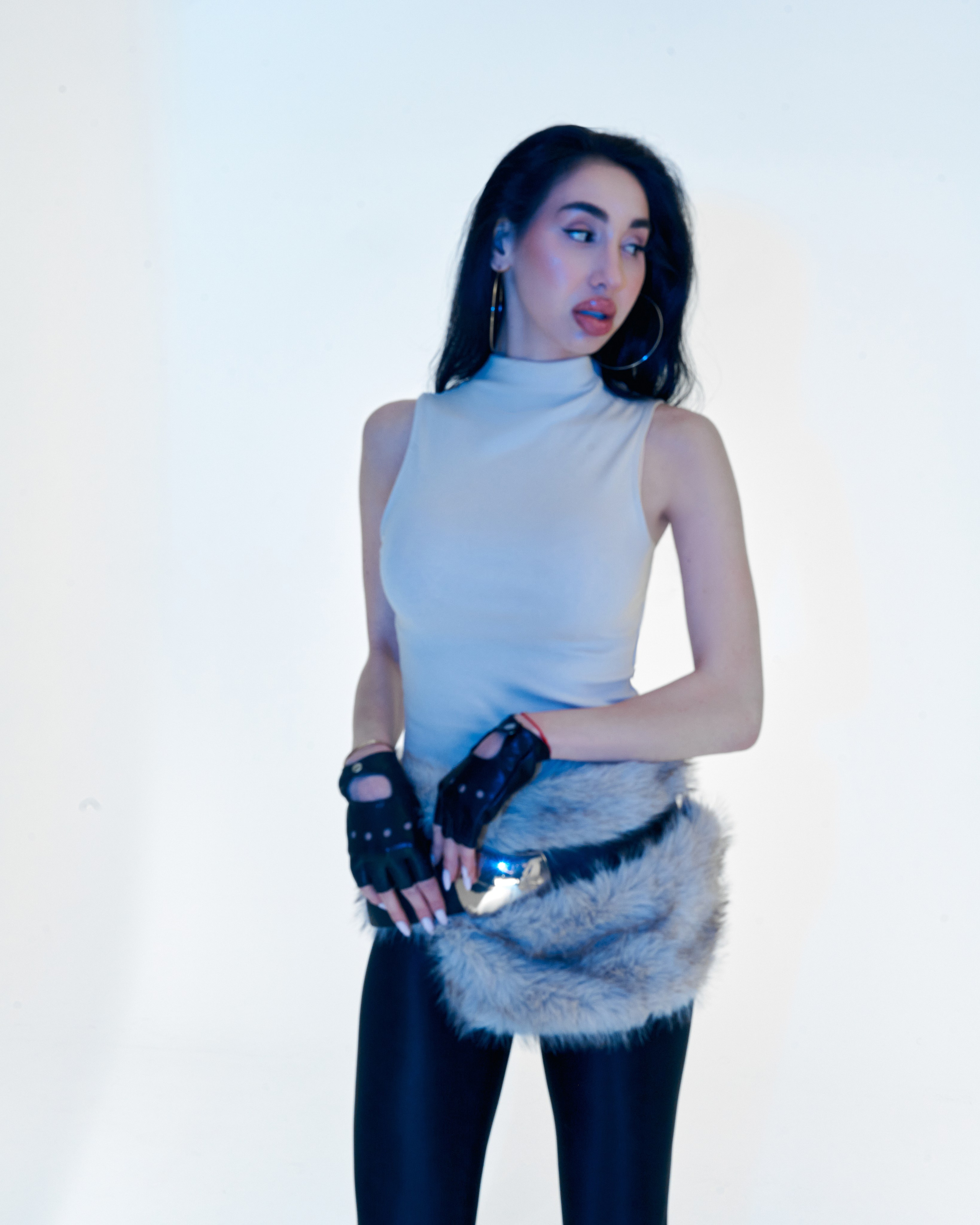 Artistic studio fashion portrait of Ester Rogovaya with blue lighting and minimalist styling