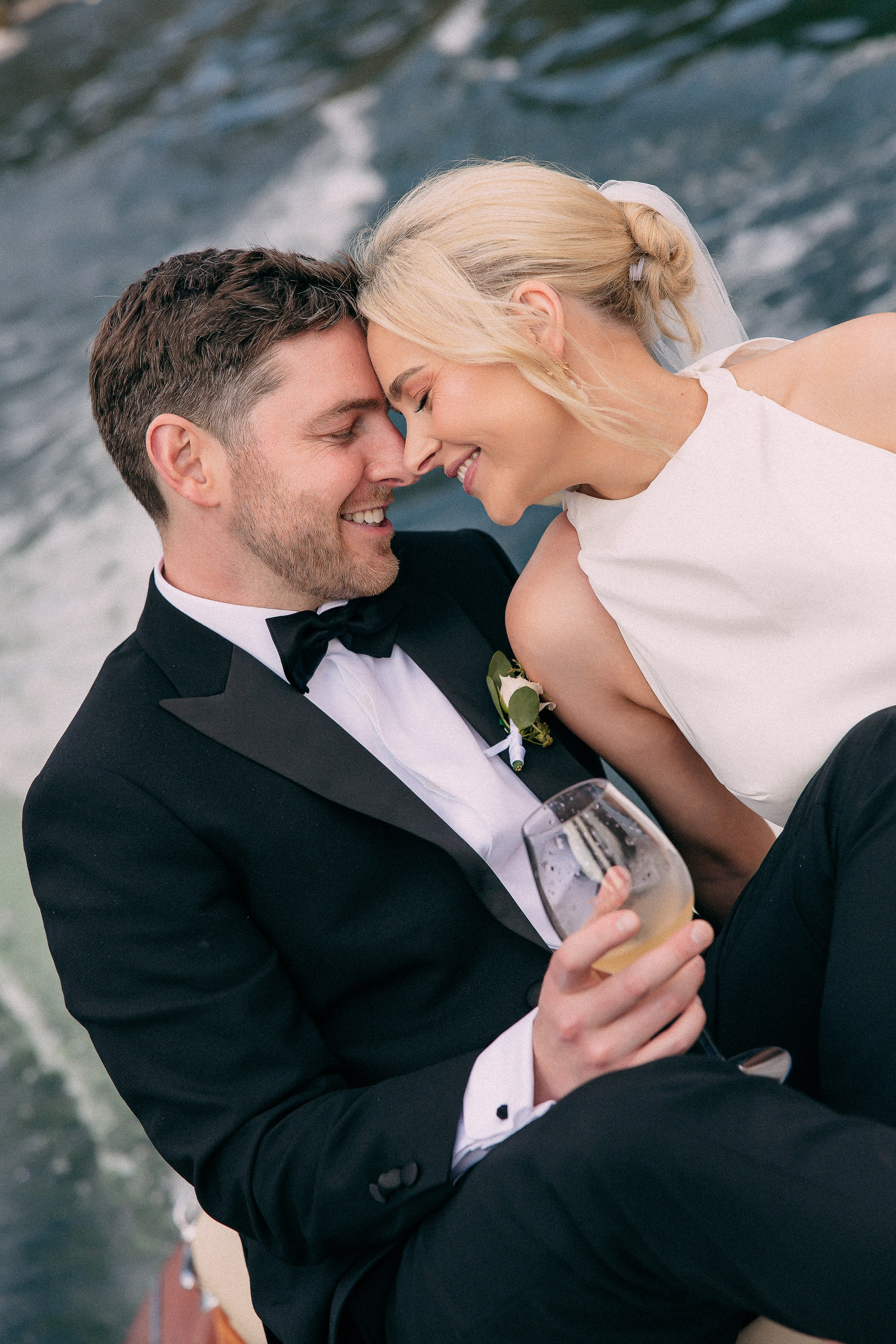 Wide shot of the bride and groom on the boat at Villa Lario, Lake Como, Italy