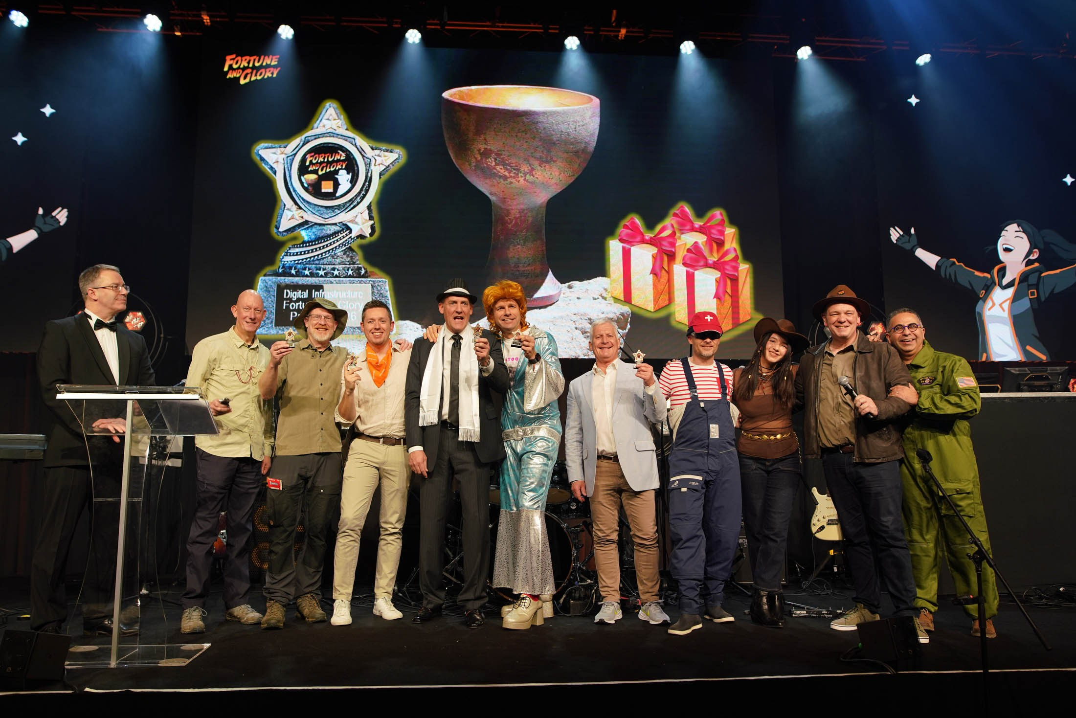 Awardees pose for their trophies on stage during a sales kick-off event and party.