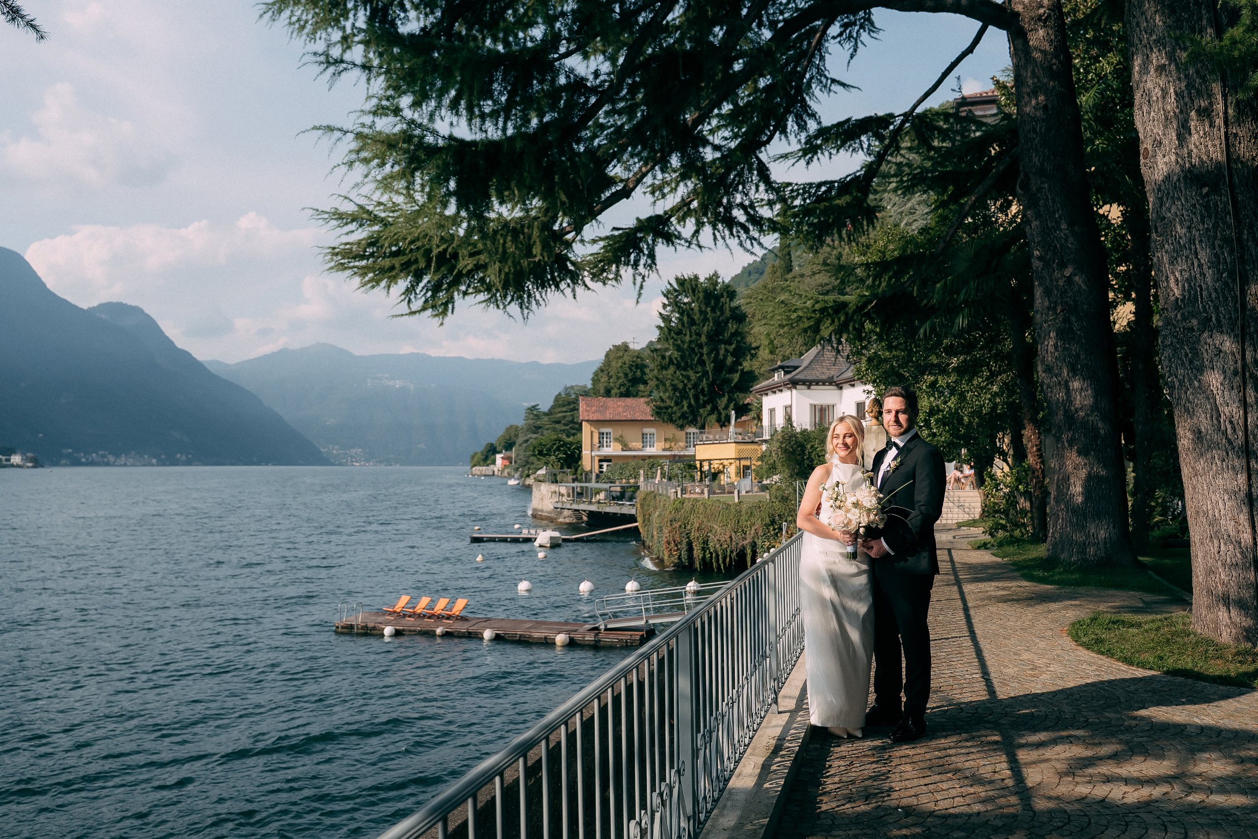 Wide view of the couple by Lake Como at Villa Lario, Italy