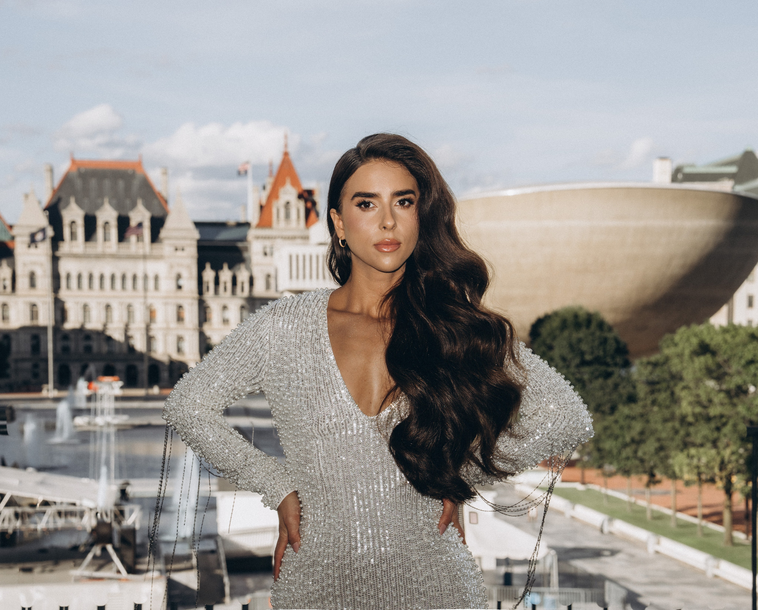Bride with flowers standing in Schenectady park.