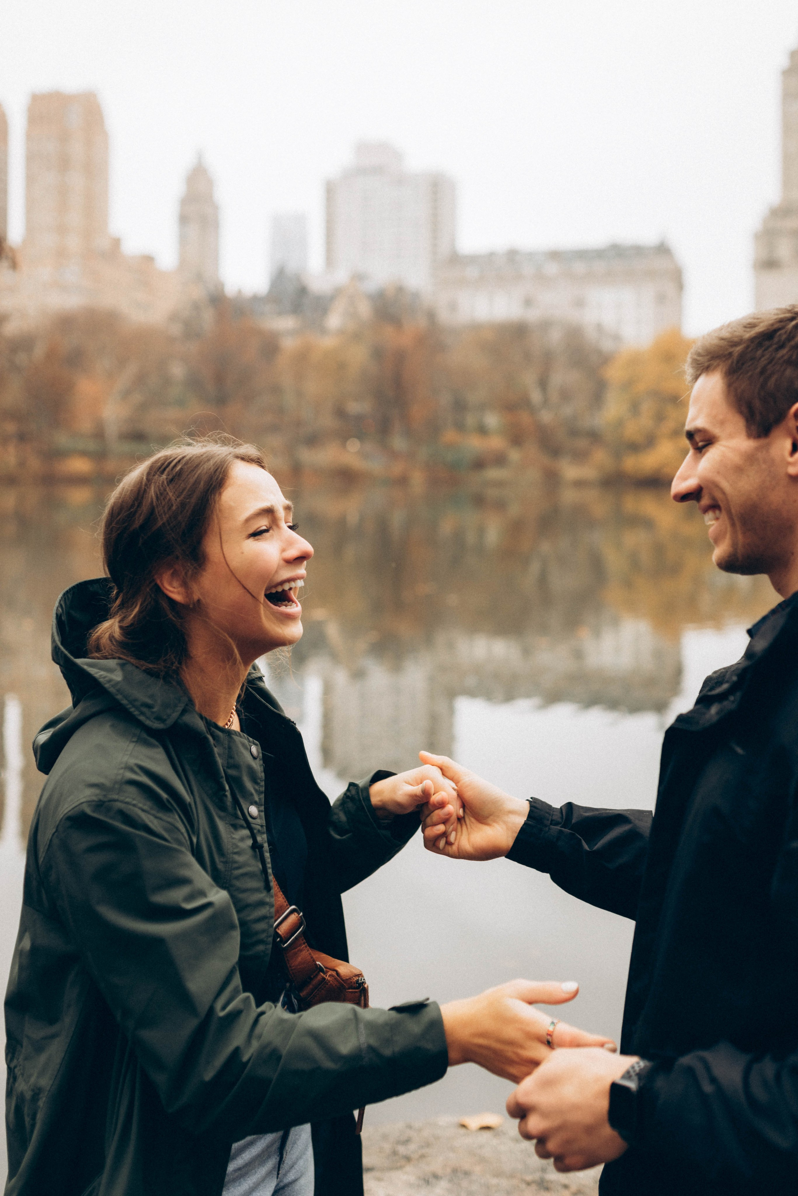 Couple hugging after proposal at Bethesda Fountain.