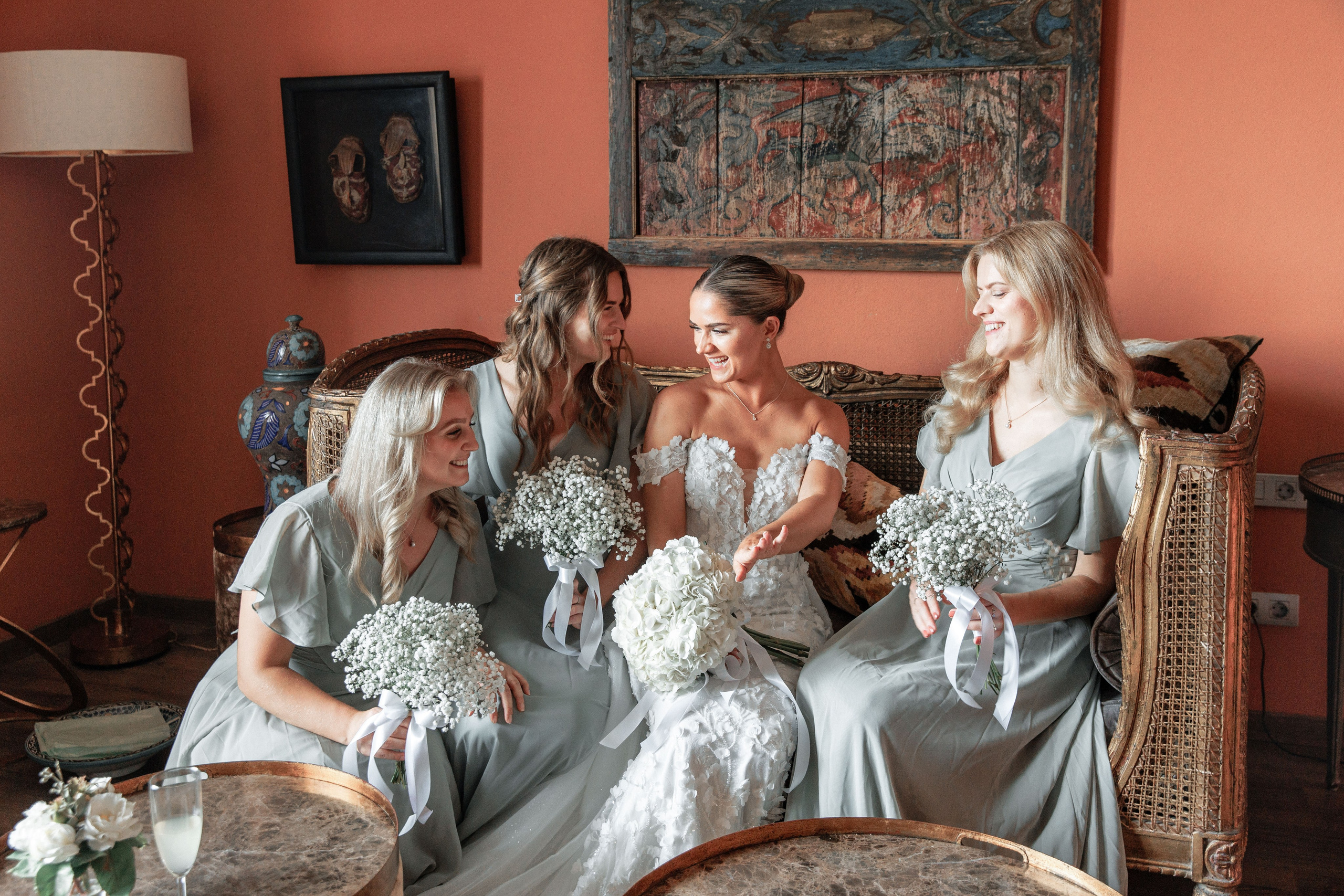 Bride surrounded by her bridesmaids in pre-wedding excitement in a stylish Barcelona venue.