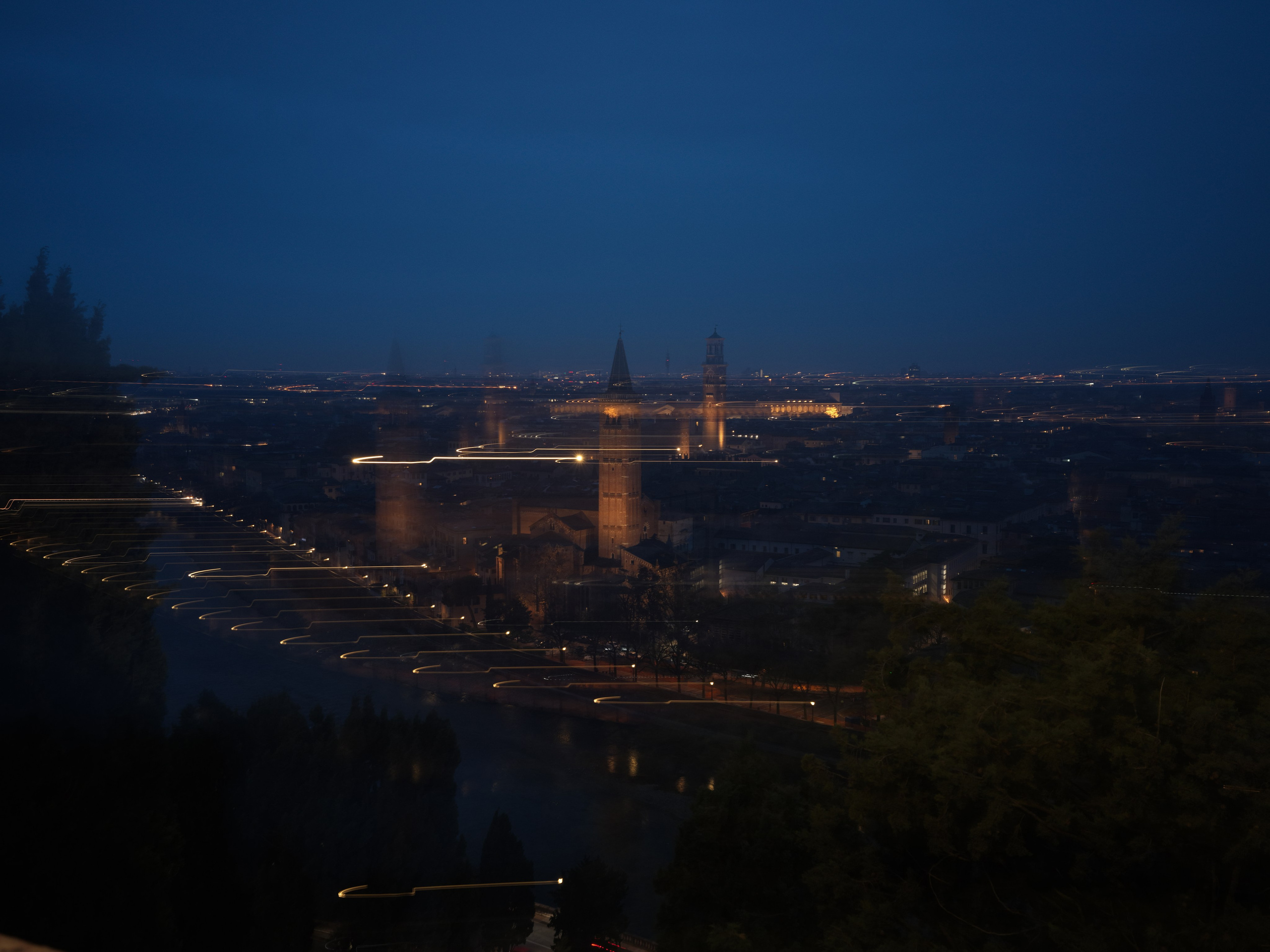 Night panorama of Verona during blue hour with city lights and Adige river