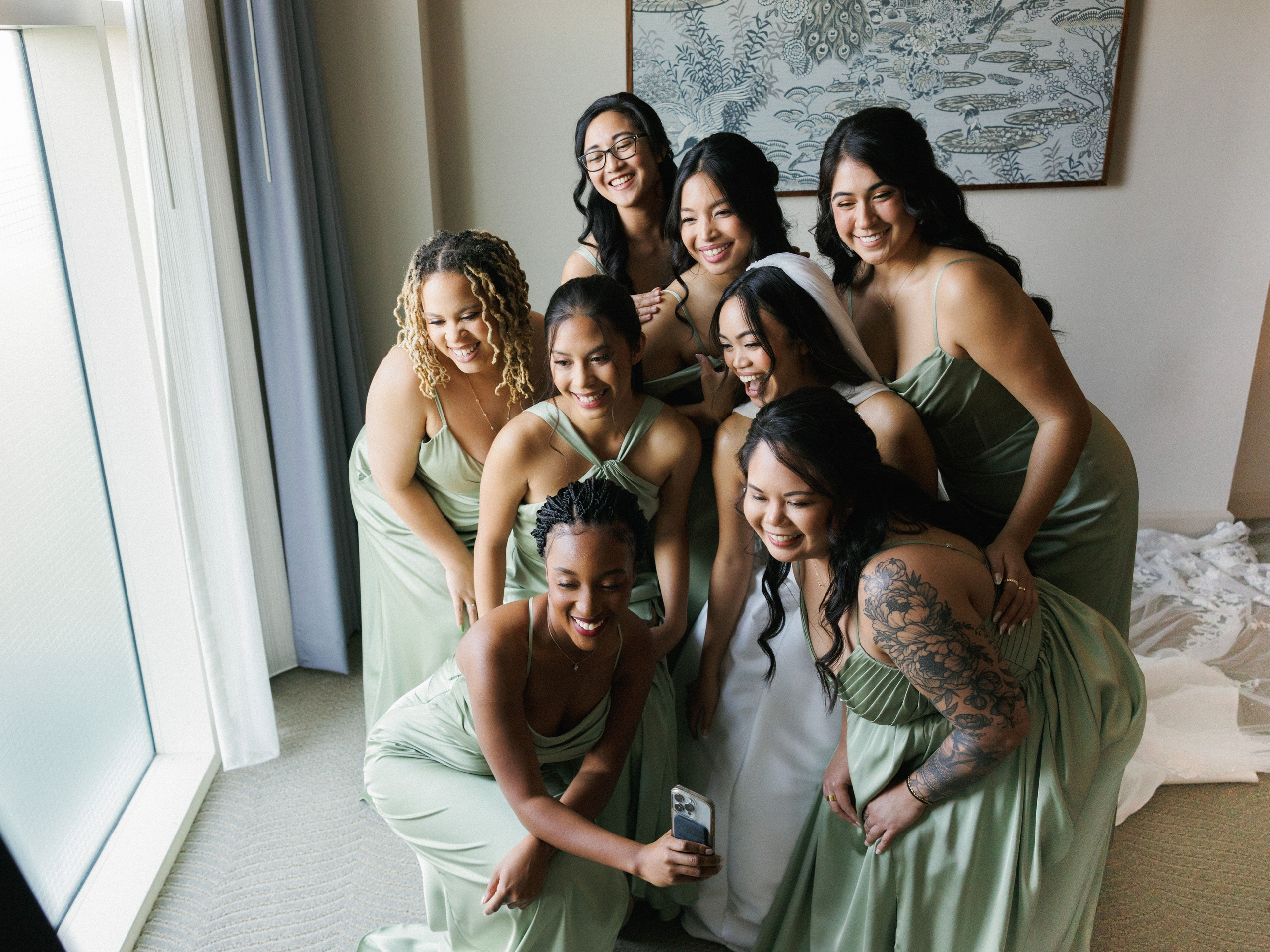 Bride and bridesmaids sharing a joyful candid moment