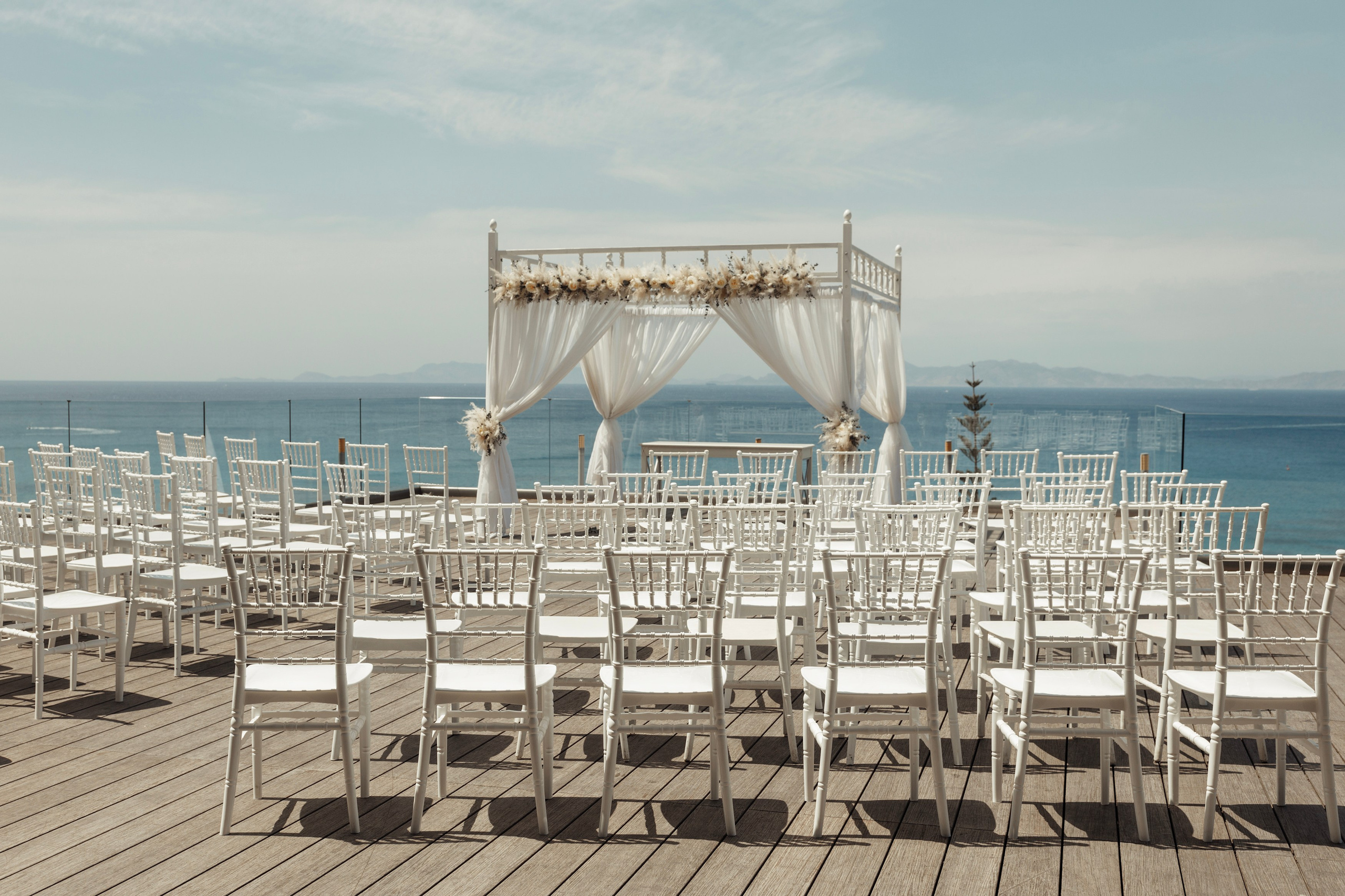 Aerial view of the wedding venue in Sheraton hotel, Rhodes, showcasing the white and blue decor blending perfectly with the Greek island scenery.