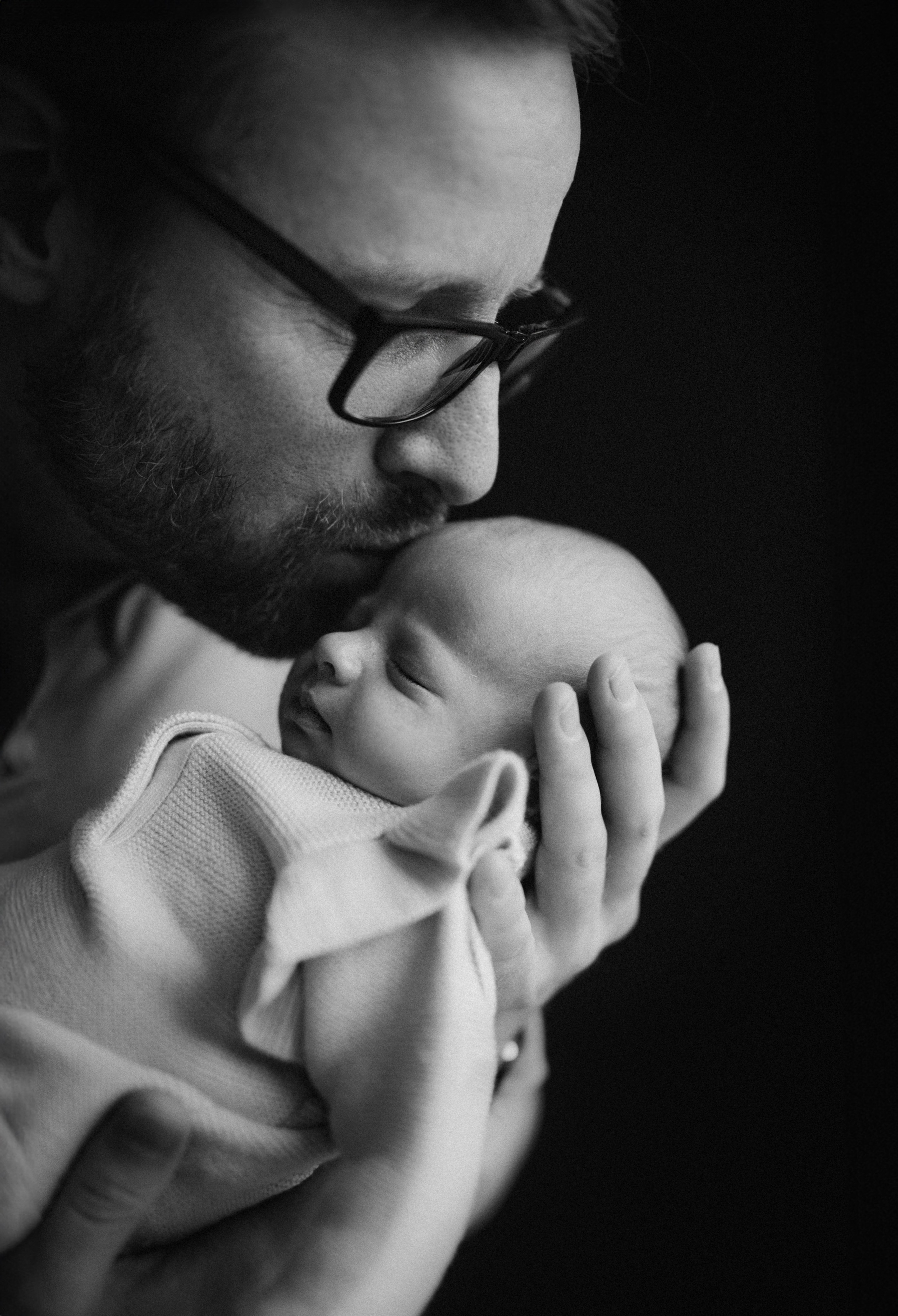 black and white portrait of father and baby