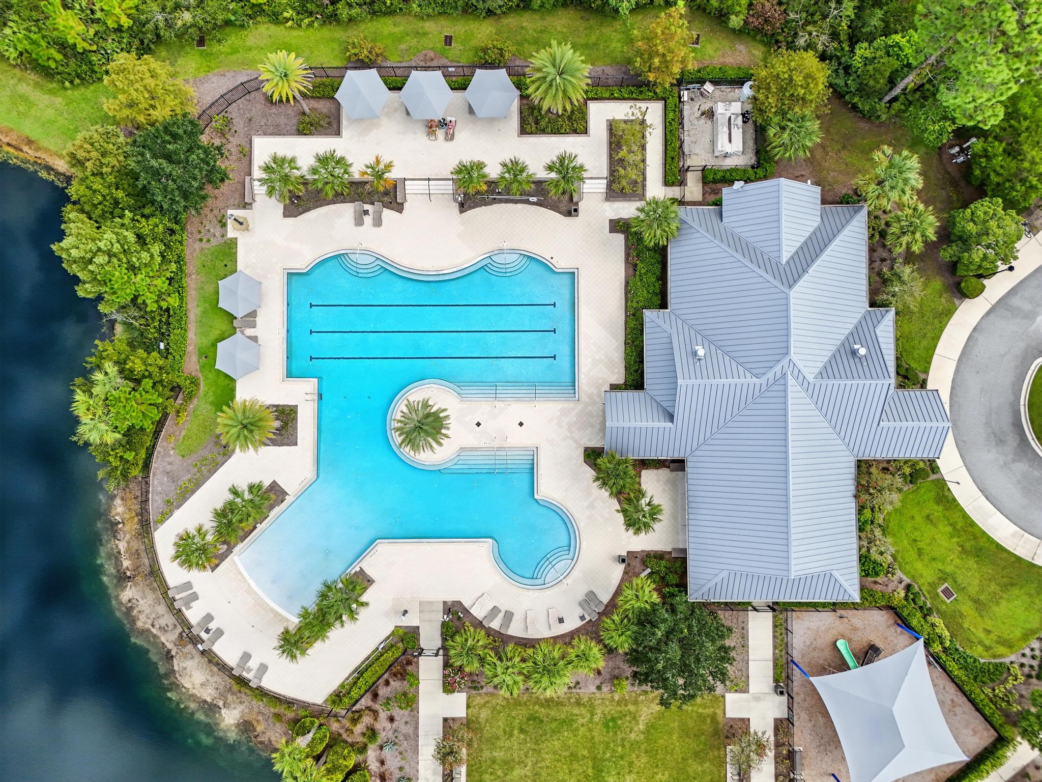 Top-down image of modern pool and blue-roof clubhouse