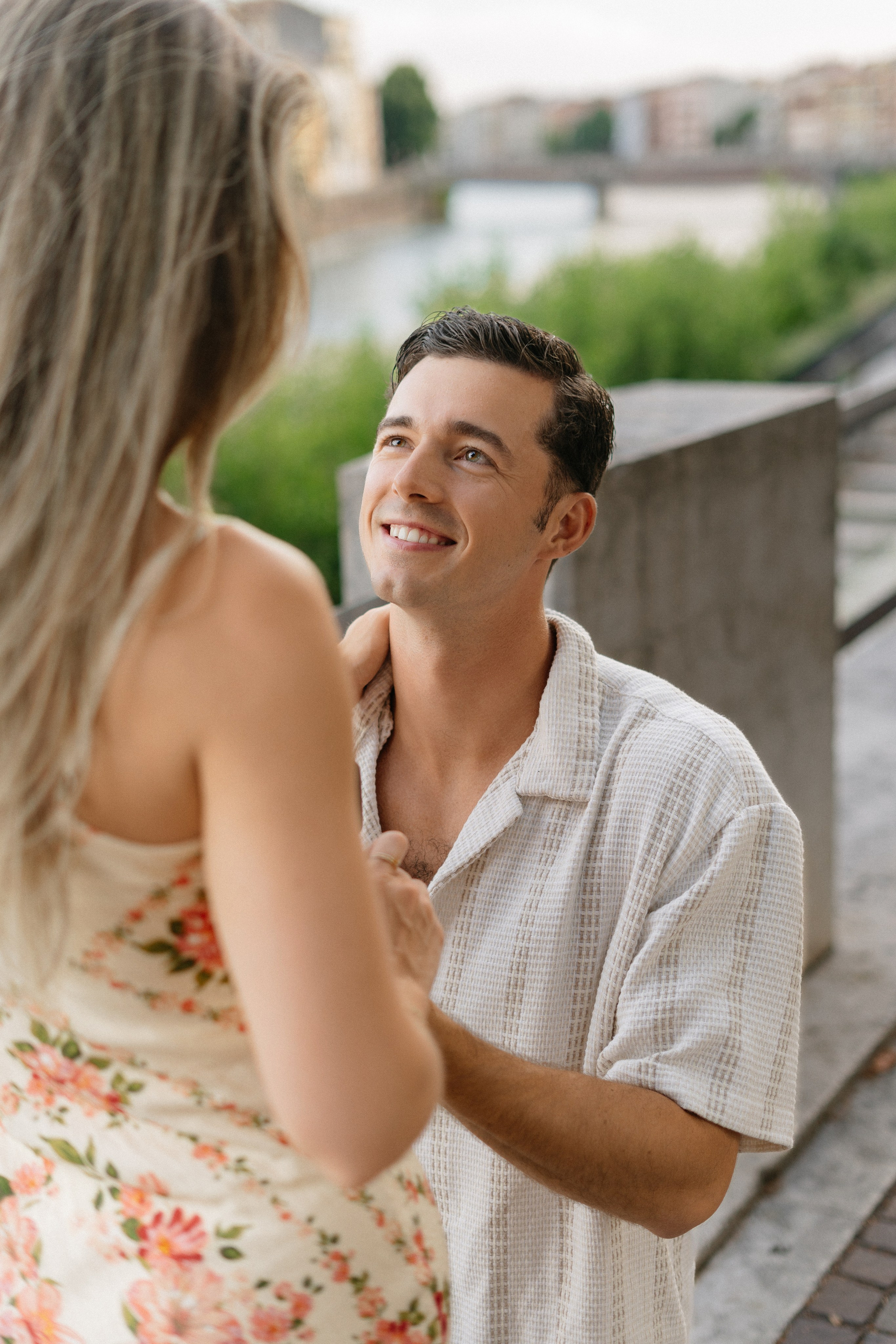 Man proposing to his partner overlooking Ponte Pietra in Verona, Italy