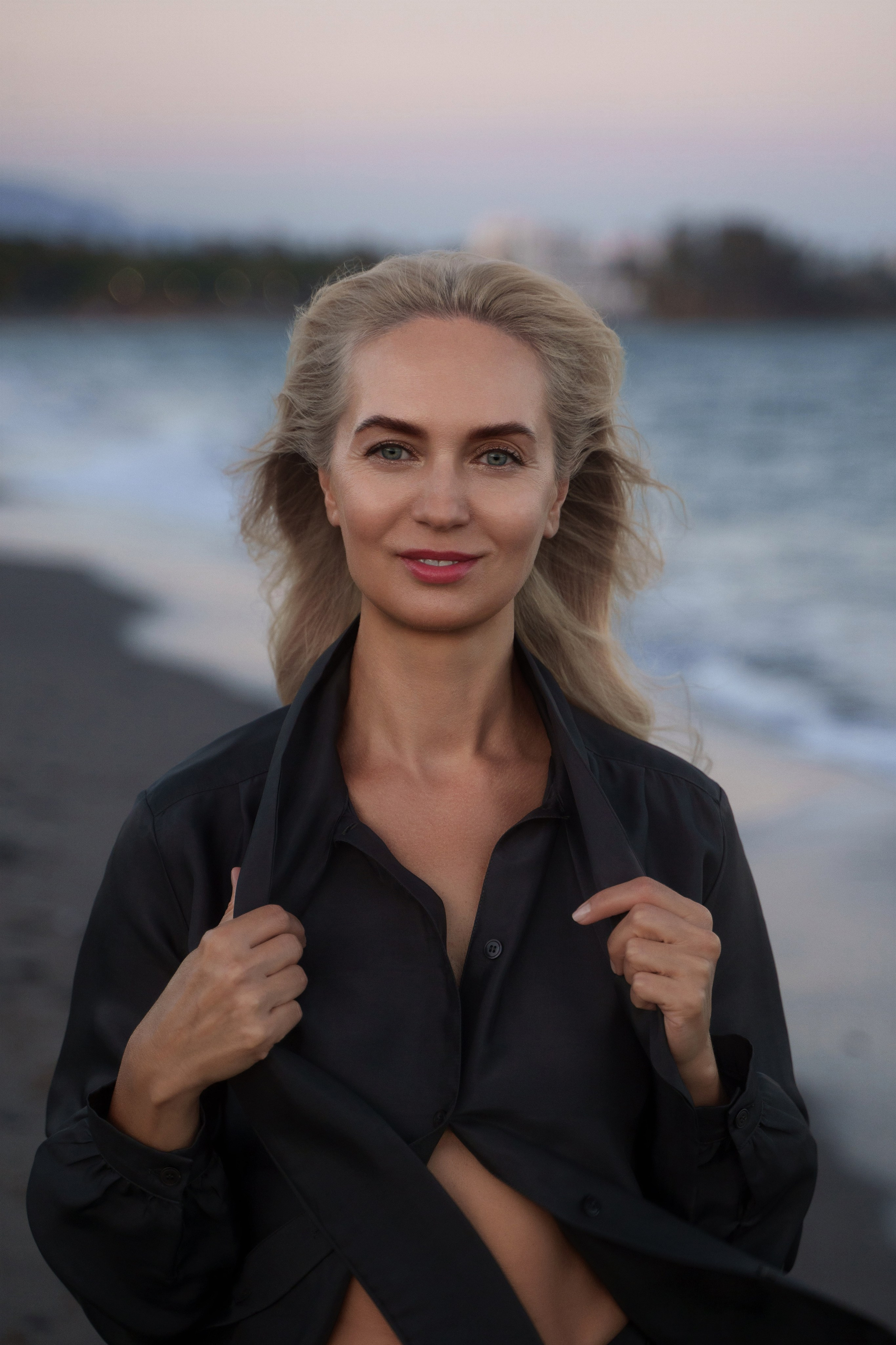 Graceful blonde model posing against the backdrop of Estepona sandy beach