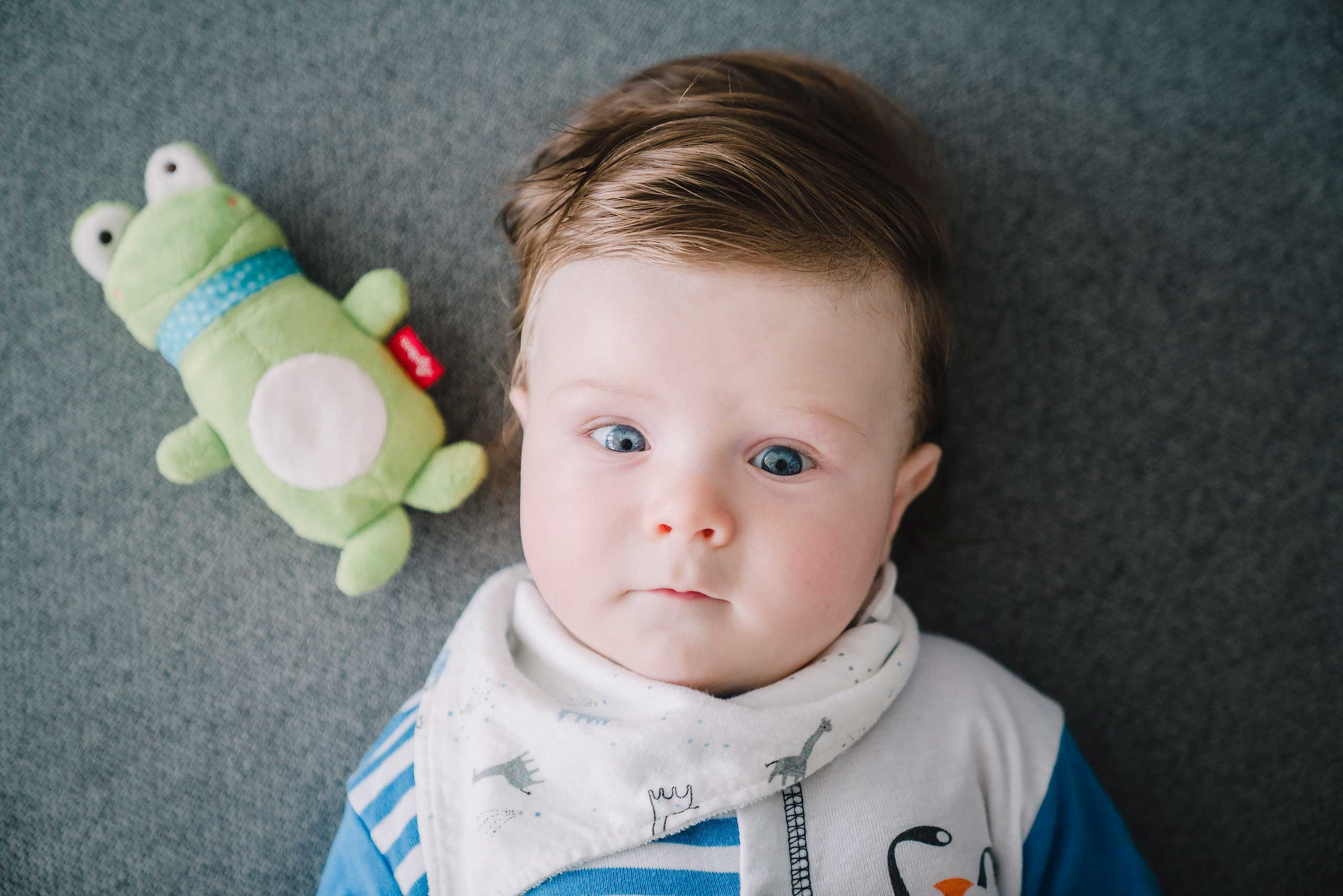 Amazed baby and a toy