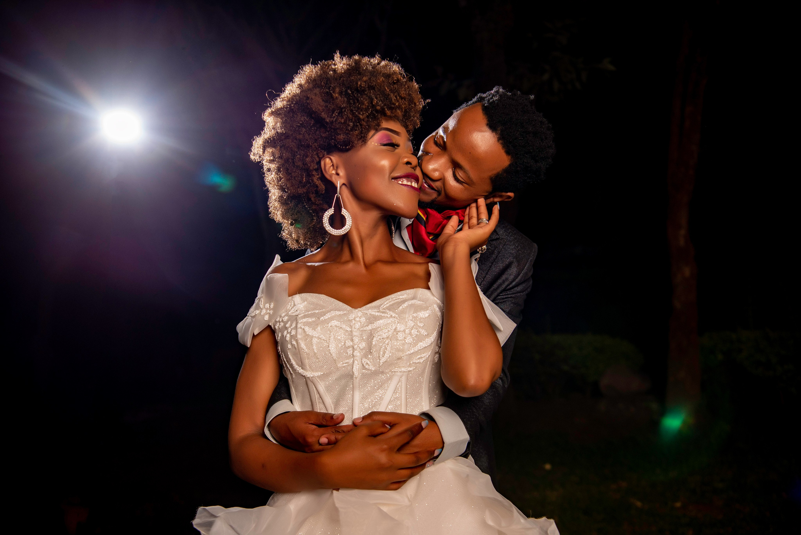 A candid portrait of a bride and groom embracing each other during a wedding photo session.