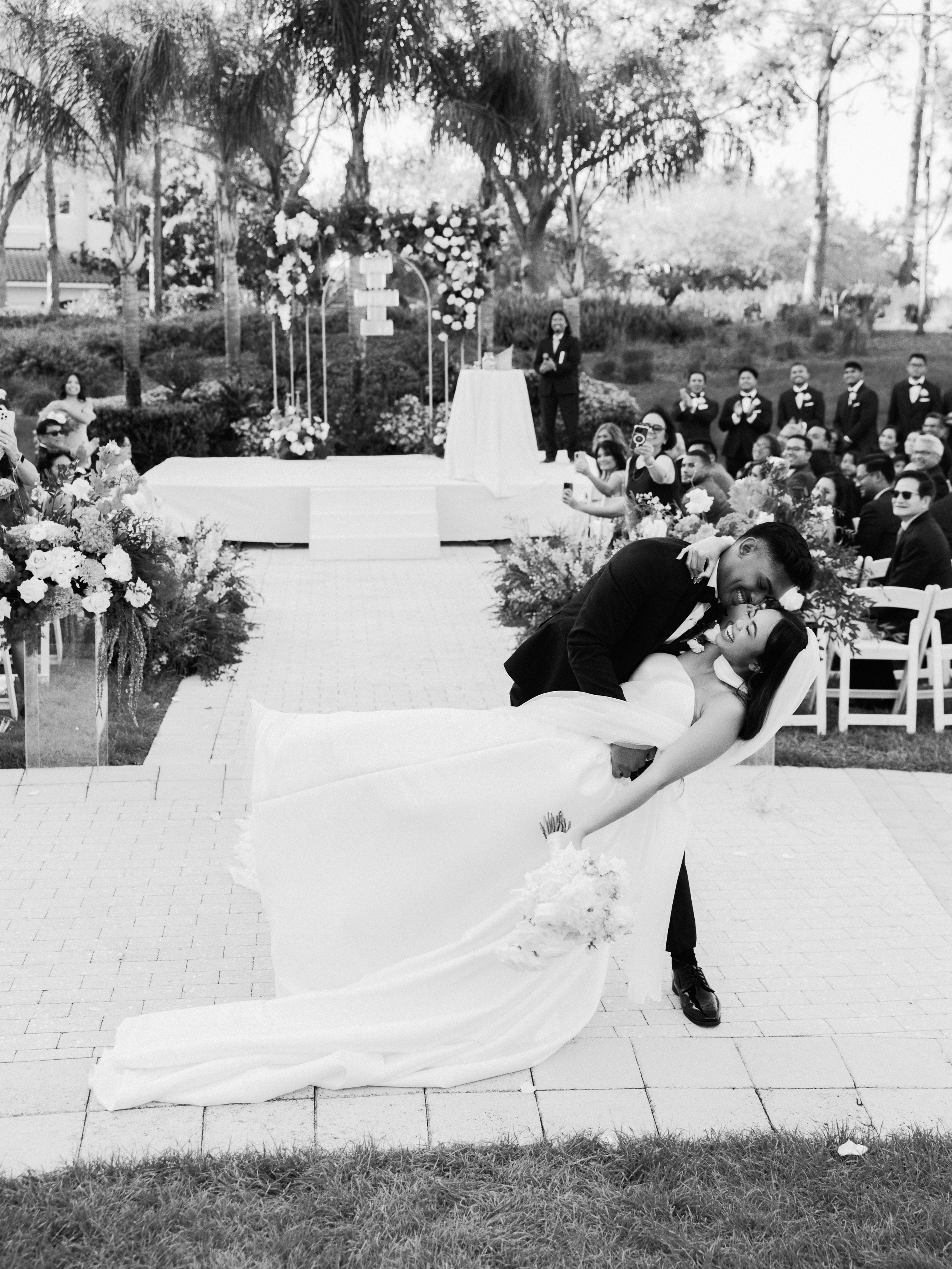 Black-and-white view of the newlyweds at their ceremony
