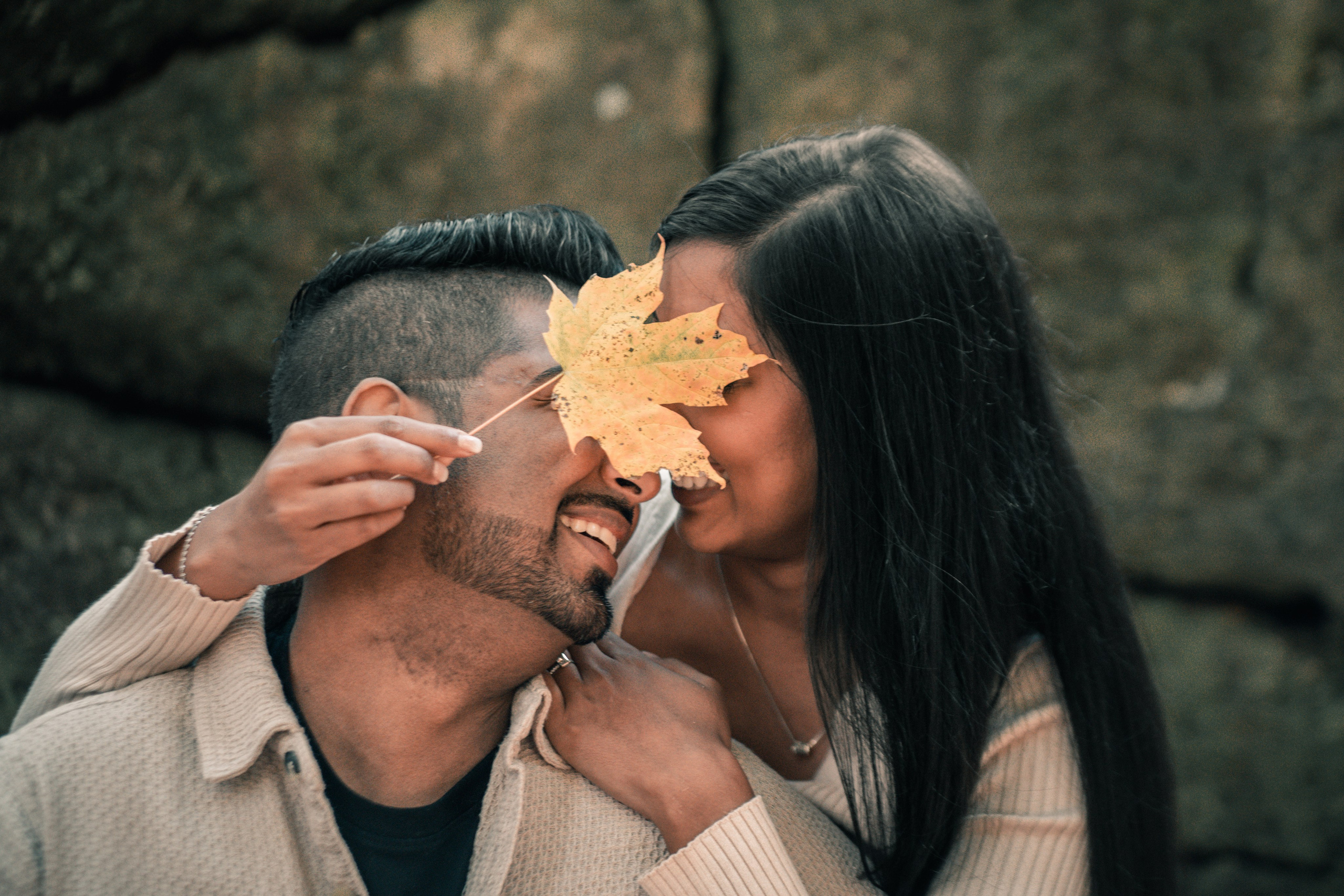 Couple enjoying a sunset moment by the lake during their engagement photoshoot.