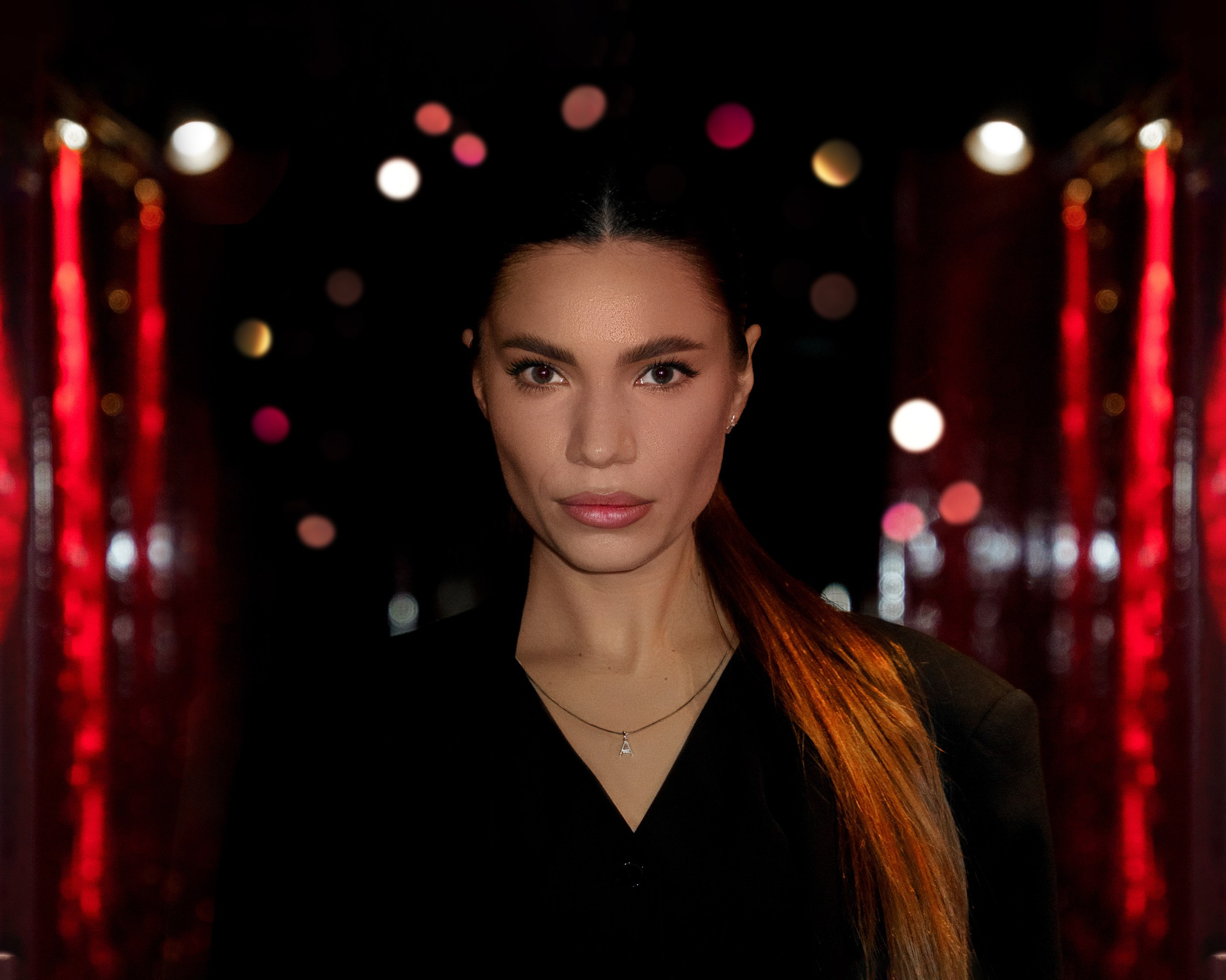 Female portrait with red lights background, dramatic portrait photography